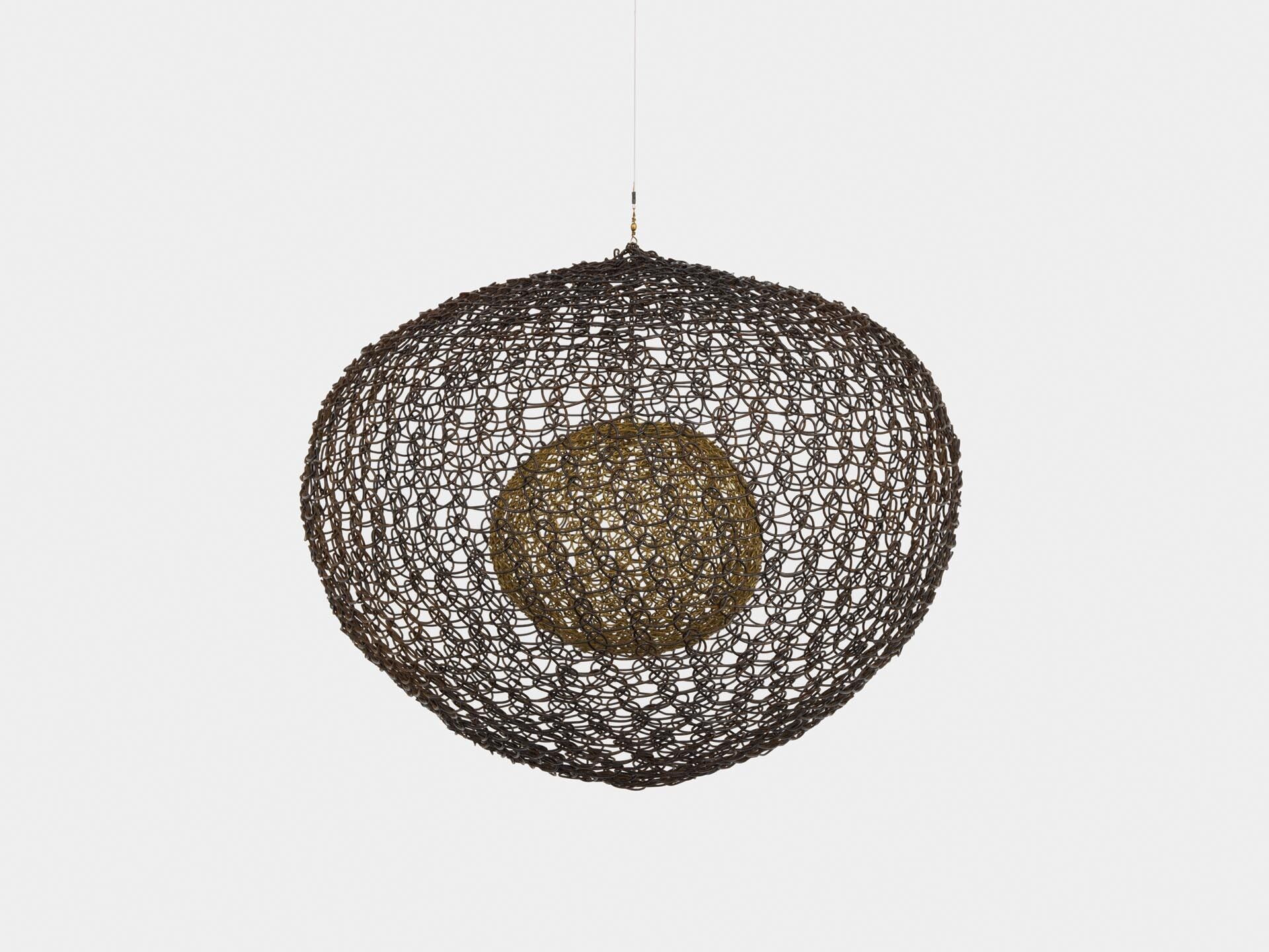 A sculpture by Ruth Asawa, titled Untitled (S.563, Hanging Six Lobed Form with Two Interior Spheres), dated 1956.