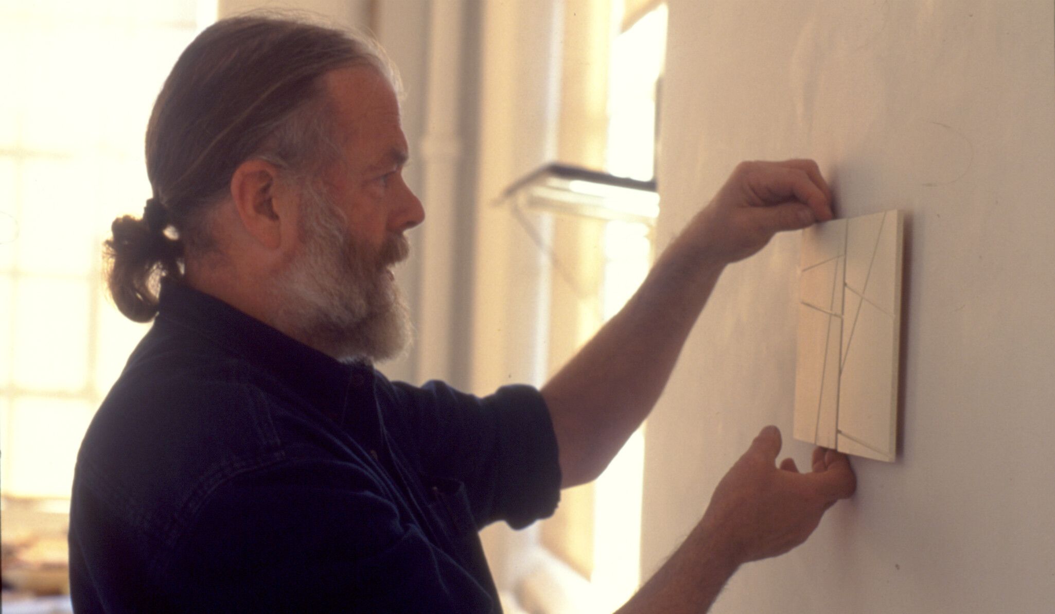 A Photo by Lawrence Markey of Fred Sandback during the installation of Fred Sandback: Recent Work, Lawrence Markey Gallery, circa 1998.