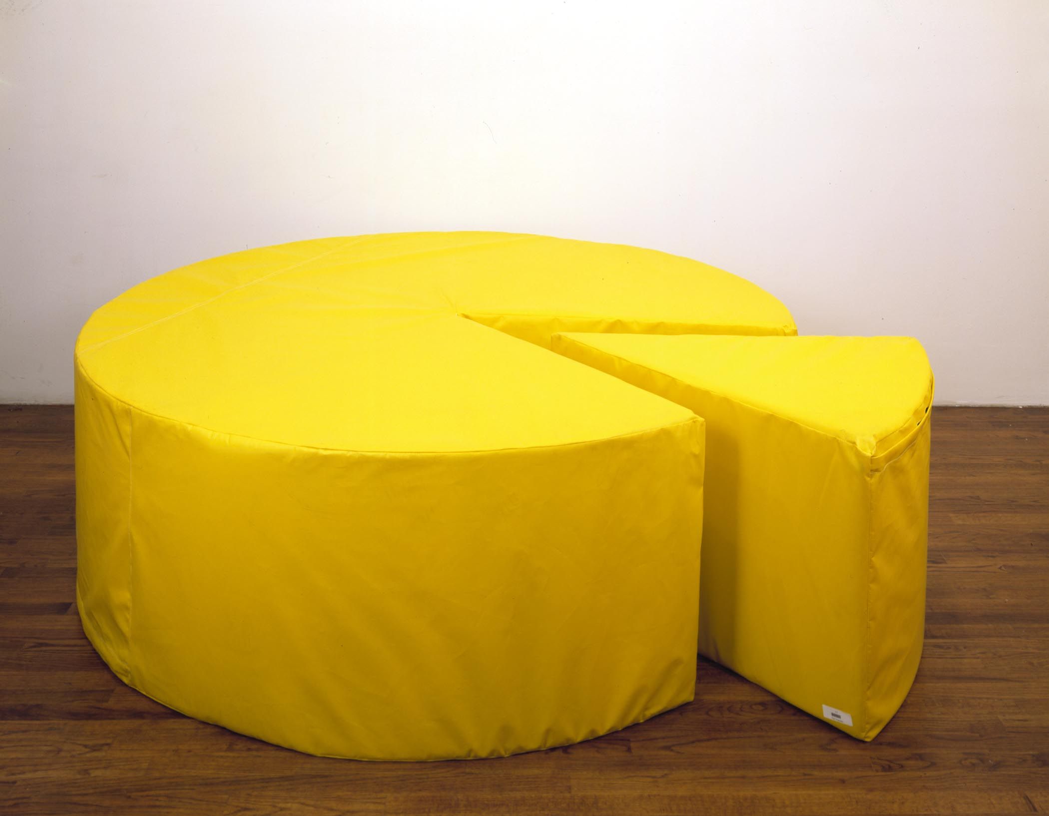 a round yellow sculpture made of yellow vinyl and foam by Jason Rhoades titled Cheese, dated 1999.