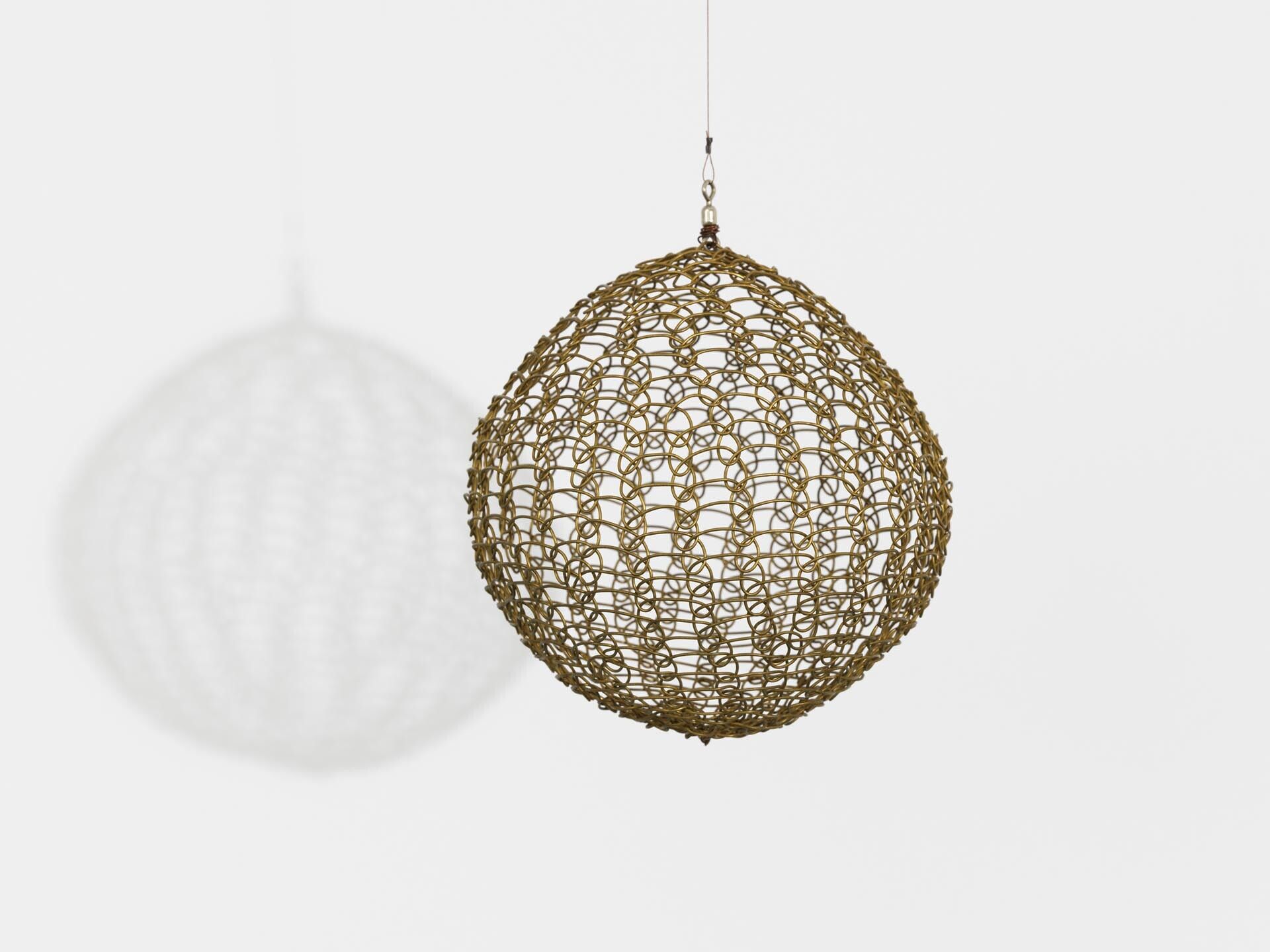 A sculpture by Ruth Asawa, titled Untitled (S.598, Hanging Sphere), dated circa 1960 to 1969.