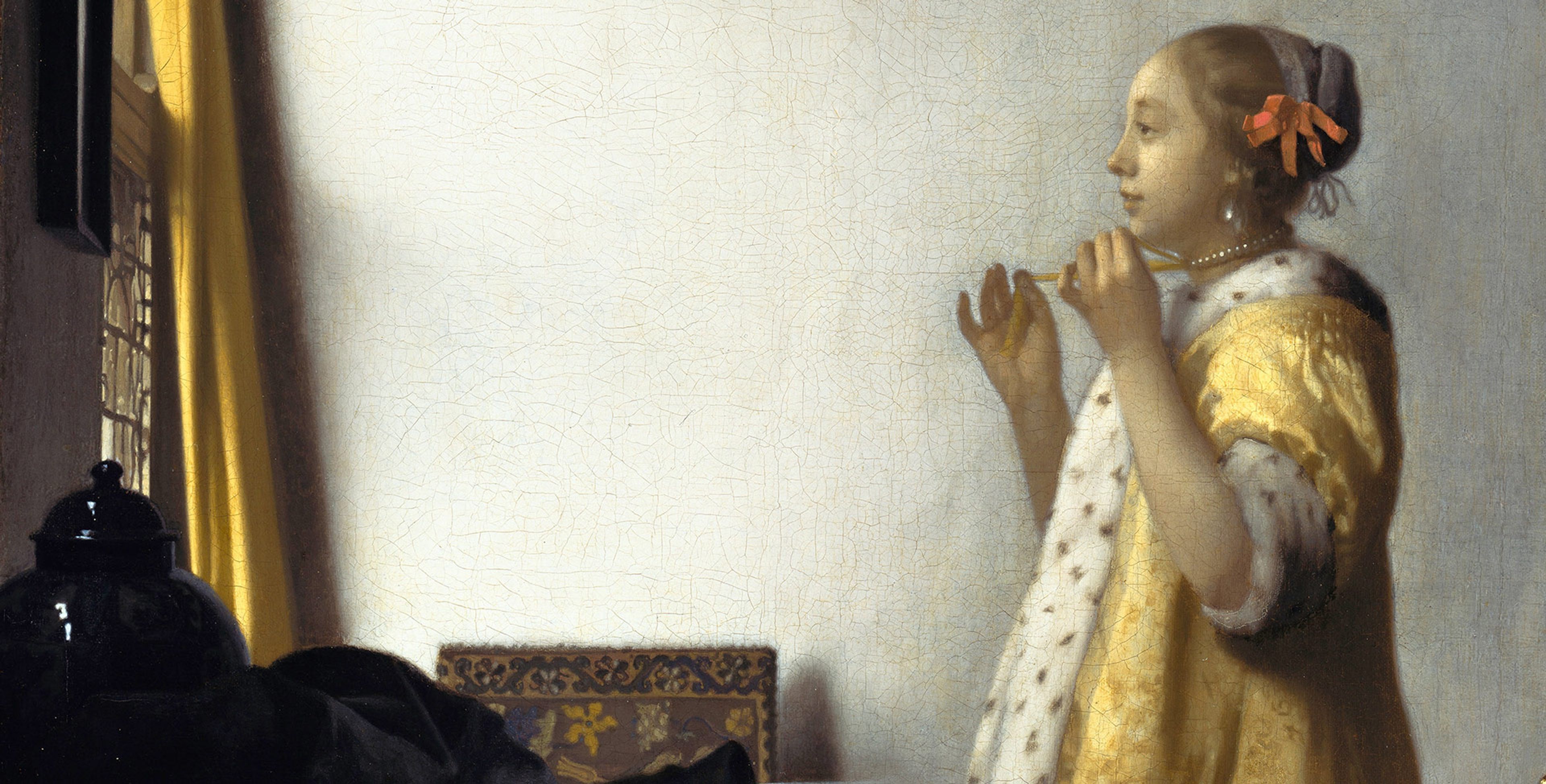 A detail from a painting by Johannes Vermeer, titled Young Woman with a Pearl Necklace, dated 1664.