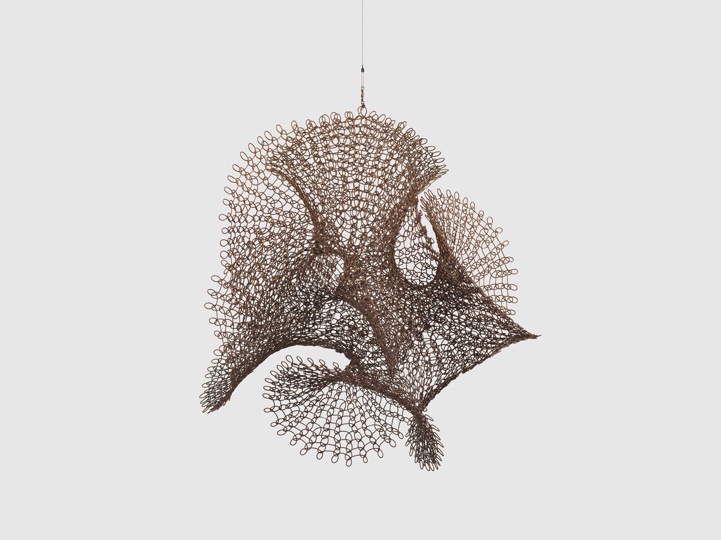 A hanging copper wire sculpture by Ruth Asawa, titled Untitled (S.590, Hanging Open Undulating Form), circa 1960.