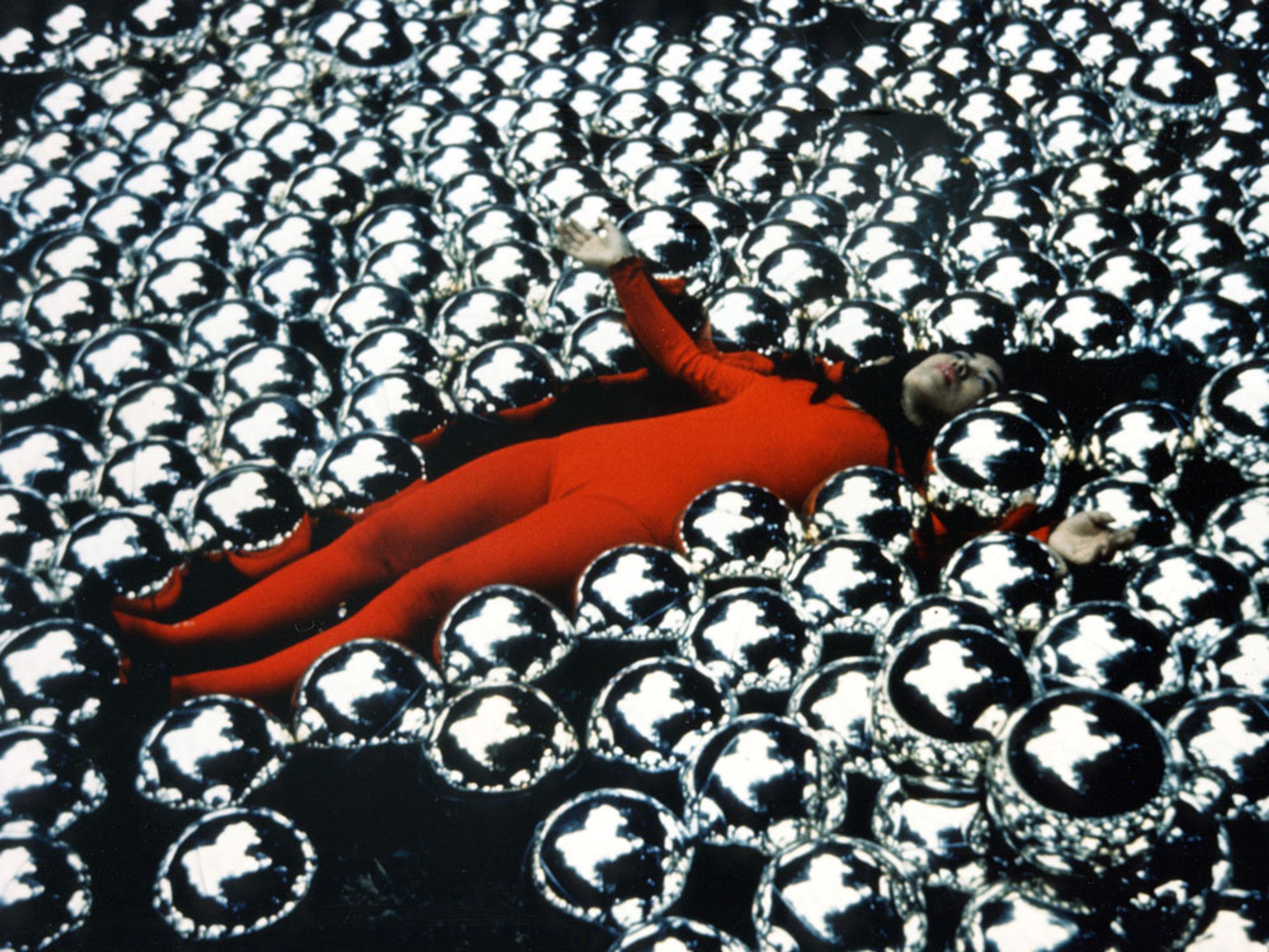 A photograph of Yayoi Kusama with¬†her installation titled Narcissus Garden at the 33rd¬†Venice Biennale, in 1966.