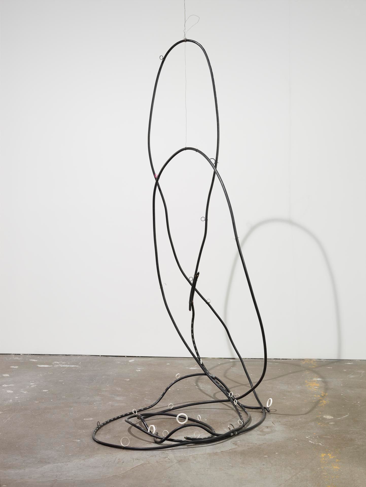 A sculpture by Al Taylor, titled Milton, Pass the Peas, dated 1992.