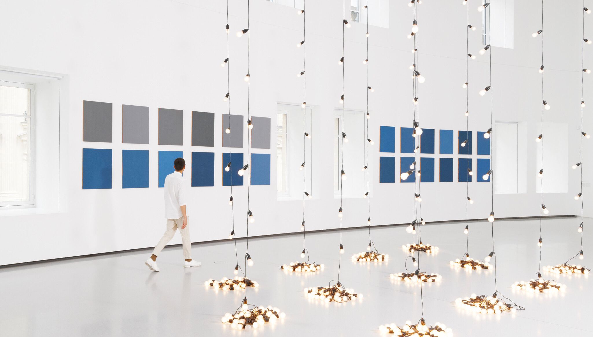 A Photo by Aurélien Mole of An Installation view, Sherrie Levine’s Gray and Blue Monochromes after Stieglitz: 1-36 (2010), on view in Une seconde d'éternité, Bourse de Commerce - Pinault Collection, Paris, 2022.