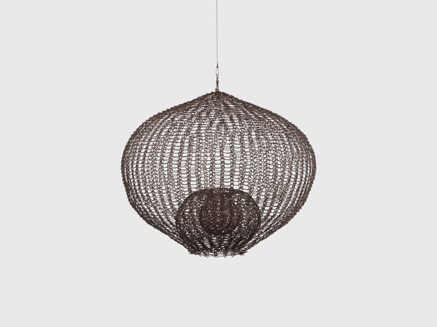 A hanging wire sculpture by Ruth Asawa, titled Untitled (S.592, Hanging, Single Lobe, Three-Layered, Continuous Form within a Form), circa 1958.