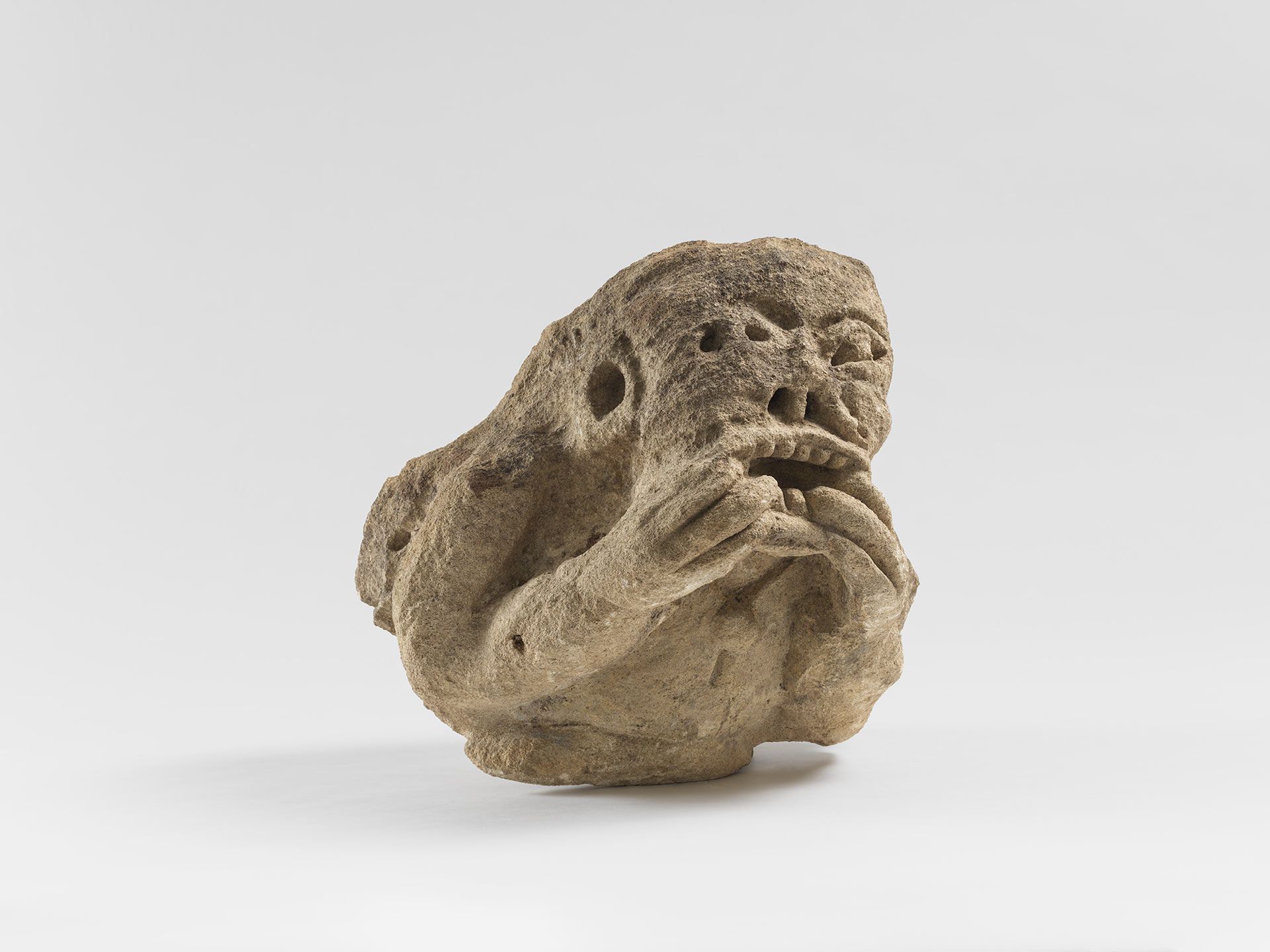 A sculpture by an anonymous artist, titled Gargoyle Pulling a Face, dated in the 15th century.