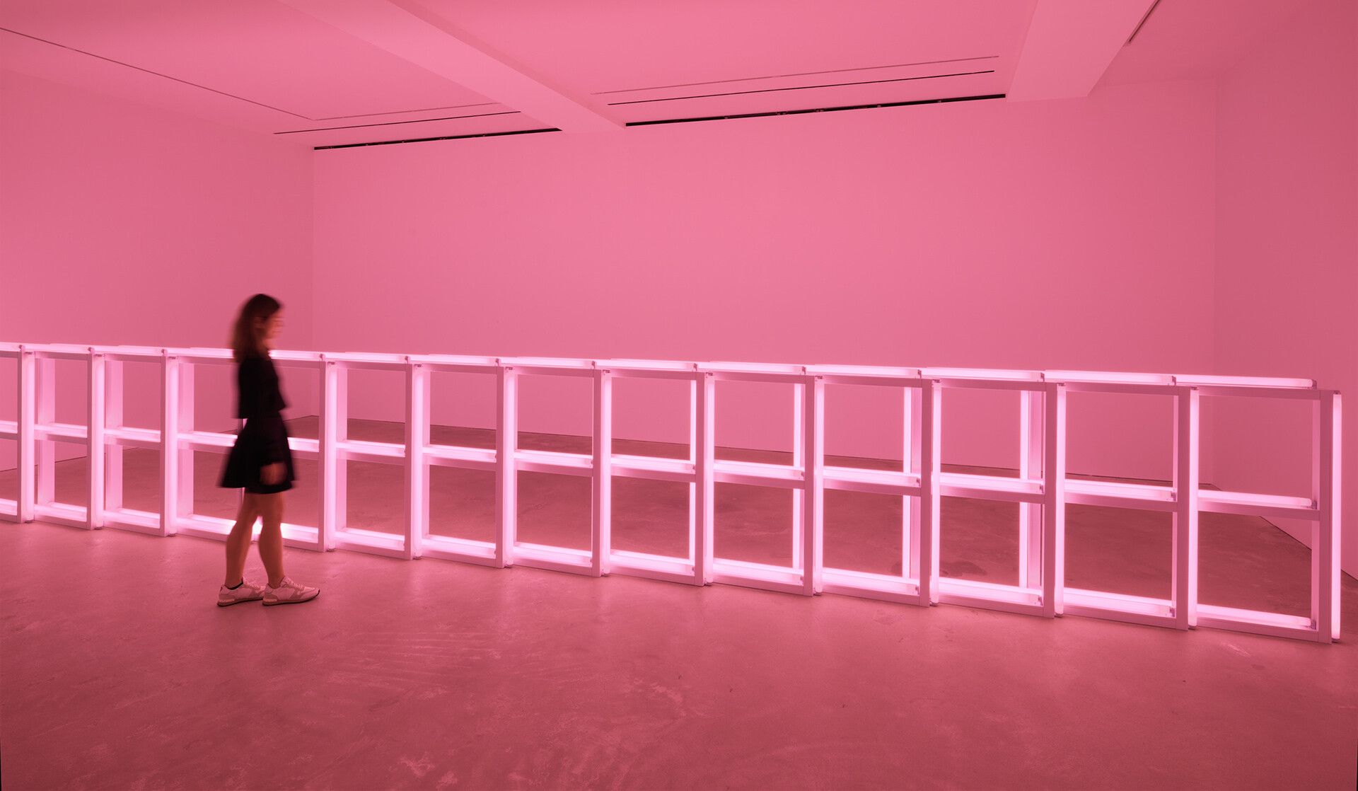 A scale shot with a human figure of an installation by Dan Flavin, called untitled, 1974.