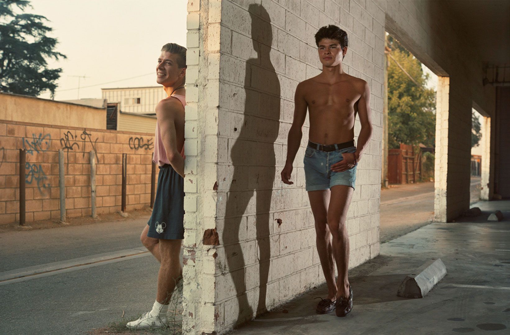 A photograph by Philip-Lorca diCorcia titled Tim Morgan Jr., 21 years old, Los Angeles, California, $25 / Joe Egure, 18 years old, Los Angeles, California, $25, dated 1990-1992.