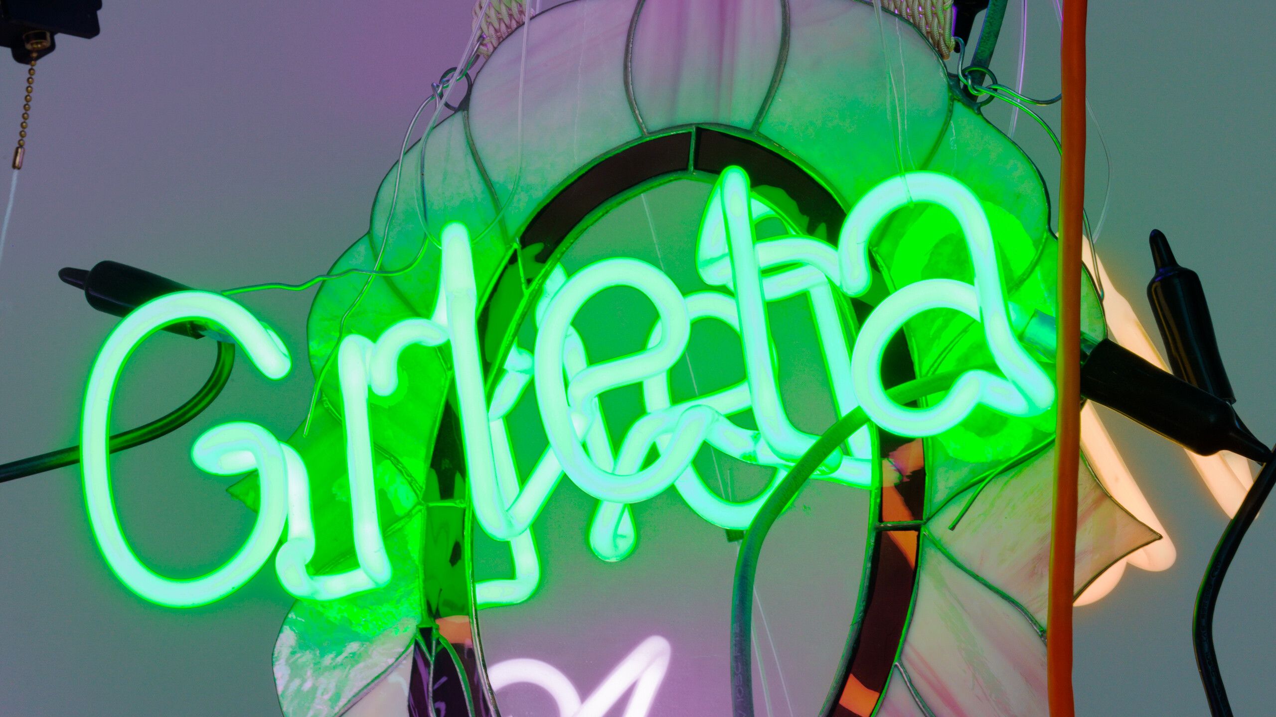 A detail of a mixed media handing sculpture with neon by Jason Rhoades, titled Chandelier 21, dated 2006.