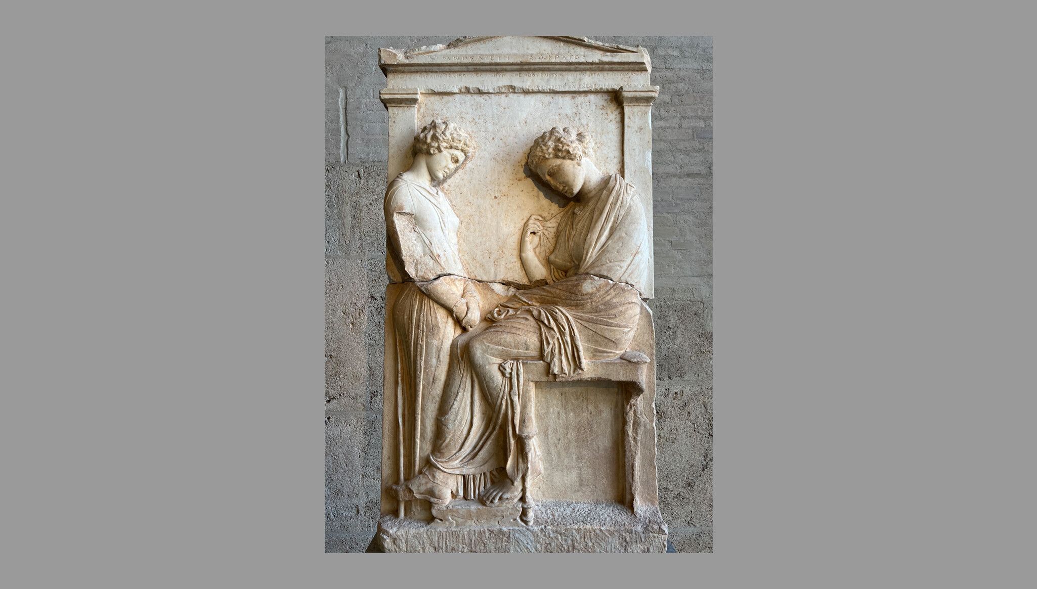 Funerary stele of Mnesarete. A young girl (left) is facing the dead woman. Inscription: ΜΝΗΣΑΡΕΤΗ ΣΩΚΡΑΤΟΣ (“Mnesarete [the daughter] of Socrates”). Attica, ca. 380 BC.