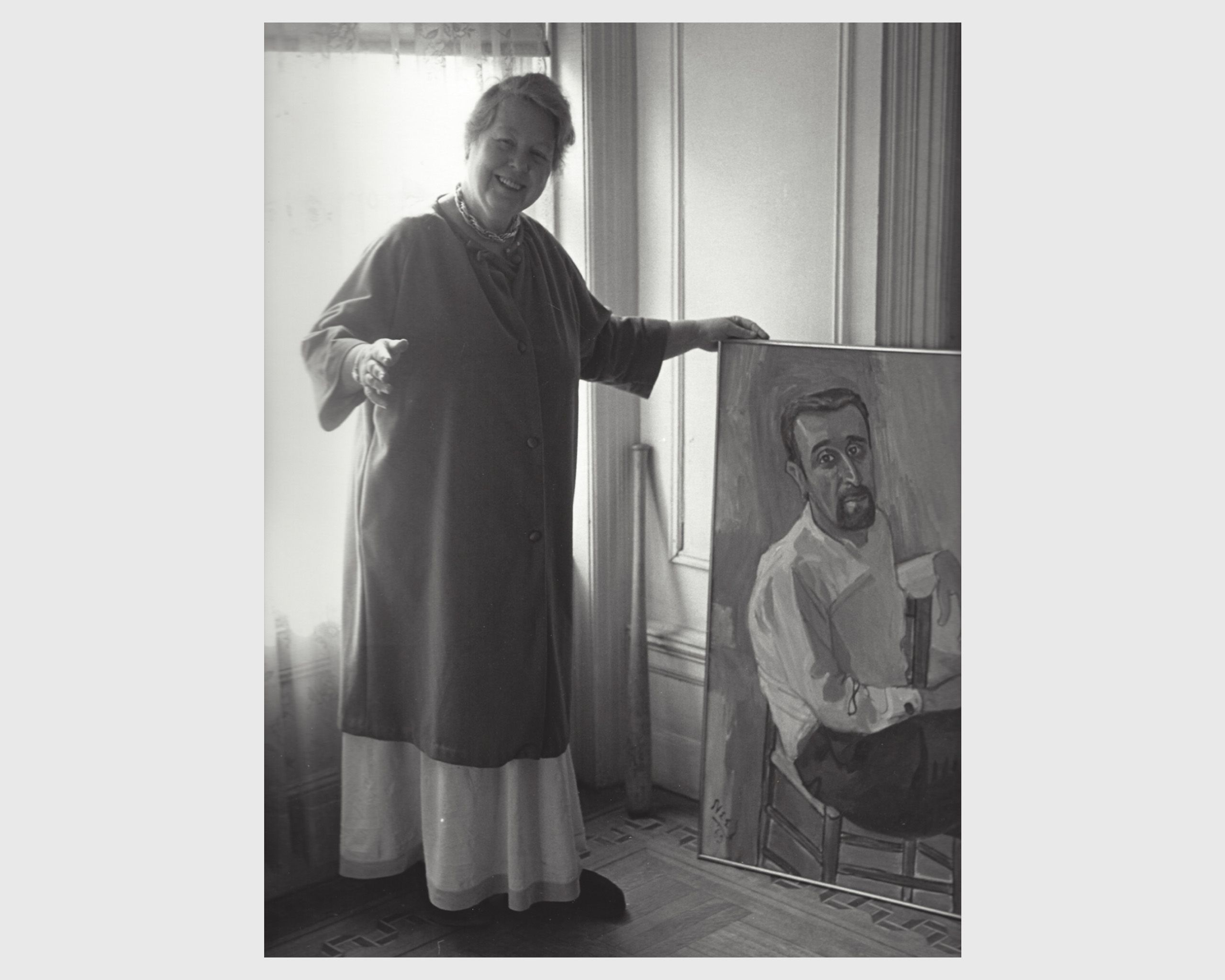 A photo of Alice Neel in her apartment on 107th and Broadway with the painting Man from Fordham, dated 1965