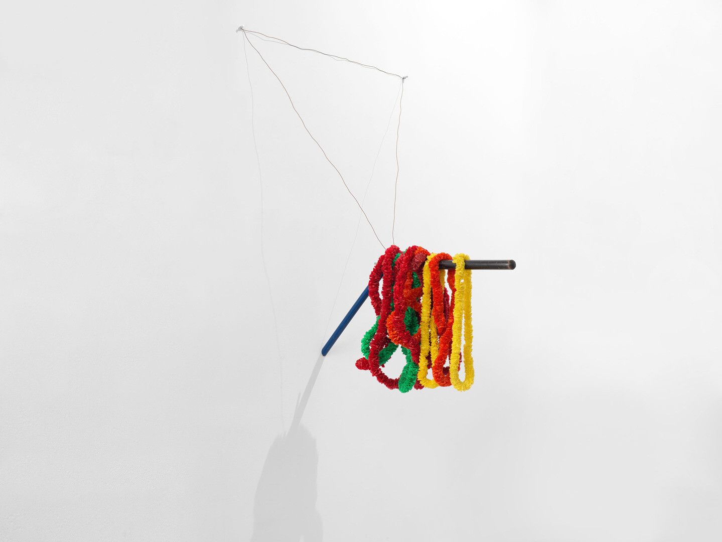 A wooden broomsticks with enamel paint, plastic leis, aluminum dowel rod, and wire sculpture by Al Taylor, titled, Layson a Stick, circa 1992 to 1993.