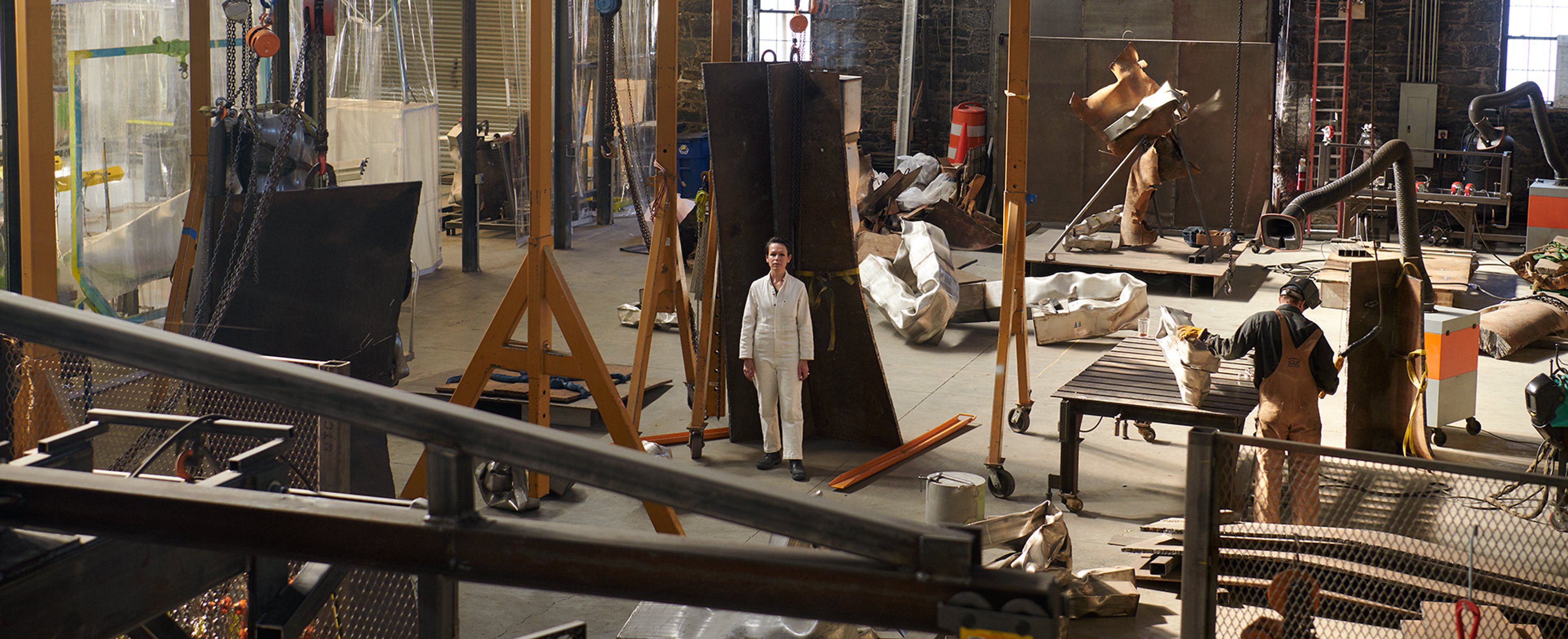 A photo by Jason Schmidt of the artist Carol Bove in her studio.