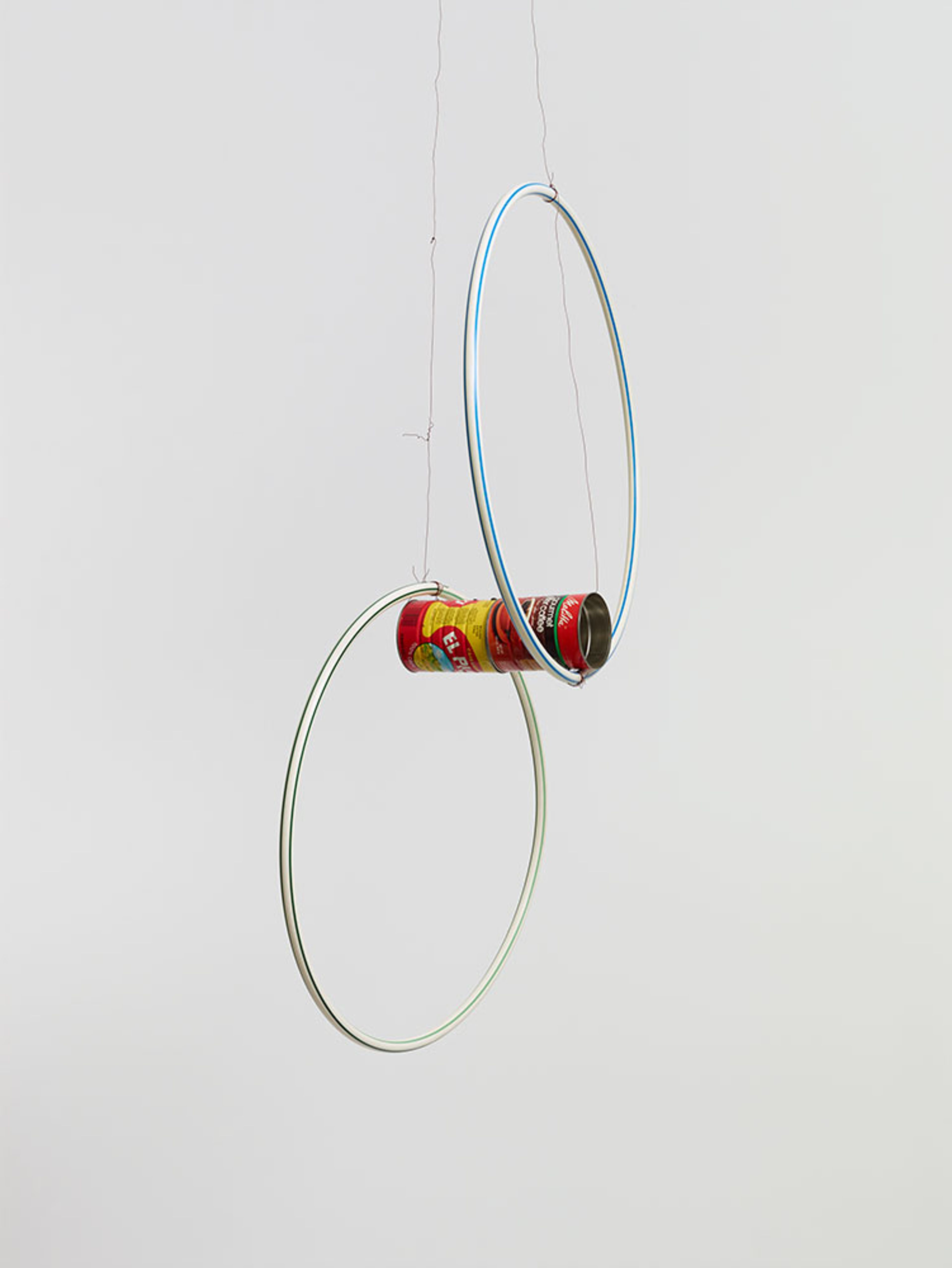 A mixed media hanging sculpture by Al Taylor, titled Cans & Hoops, dated 1993.