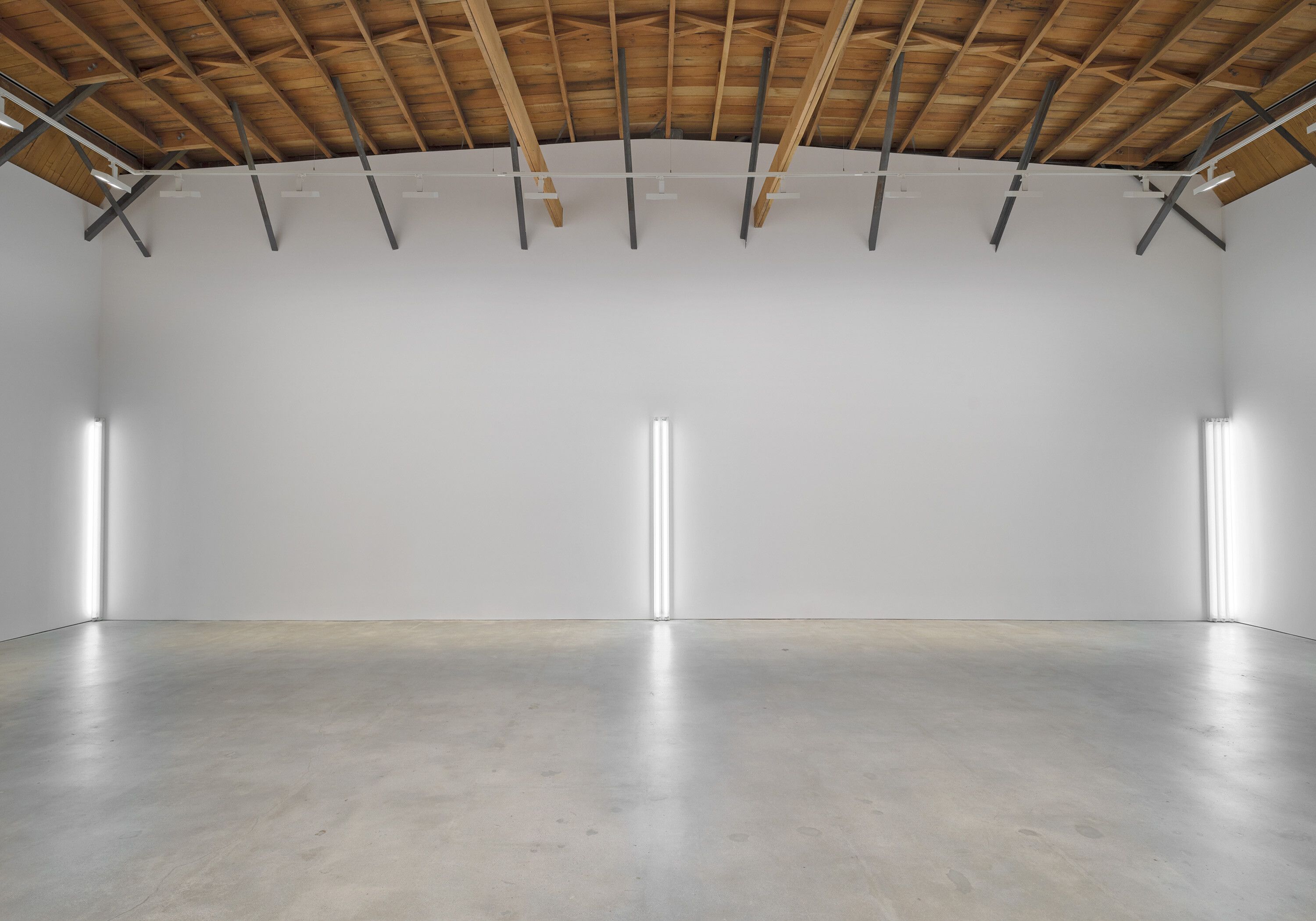 A sculpture by Dan Flavin, titled the nominal three (to William of Ockham), dated 1963.