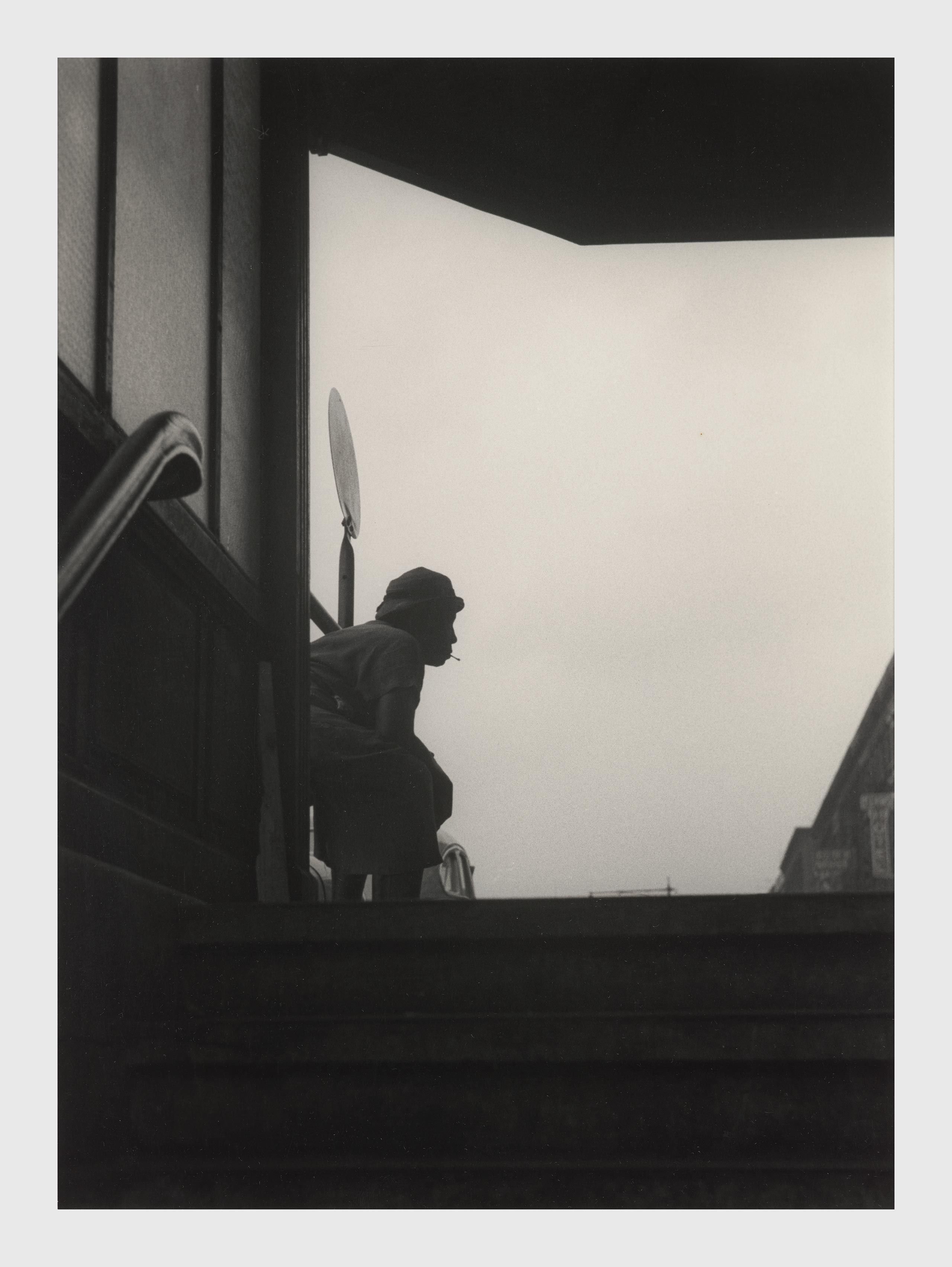 A photograph by Roy DeCarava, titled Woman resting, subway entrance, dated 1952.