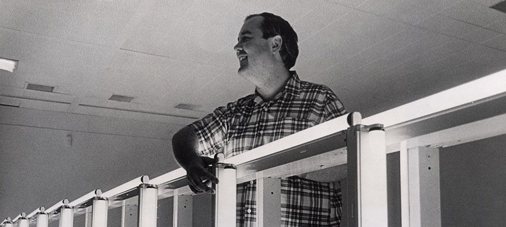 A photo of Dan Flavin installing an exhibition titled fluorescent light, etc in 1969.
