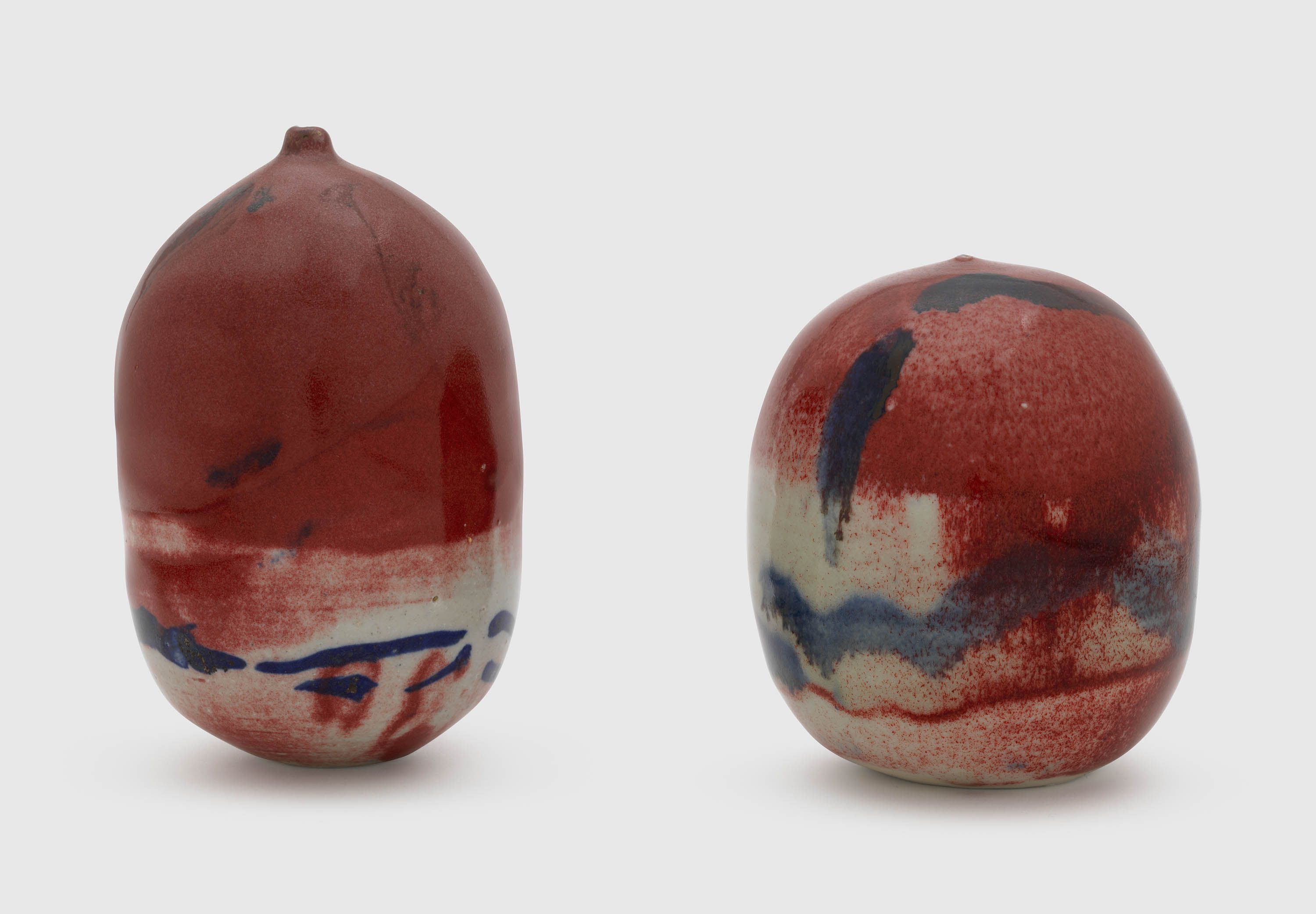 A sculpture by Toshiko Takaezu, called Untitled Pair of Copper Red Closed Forms, 1990 to 1999.