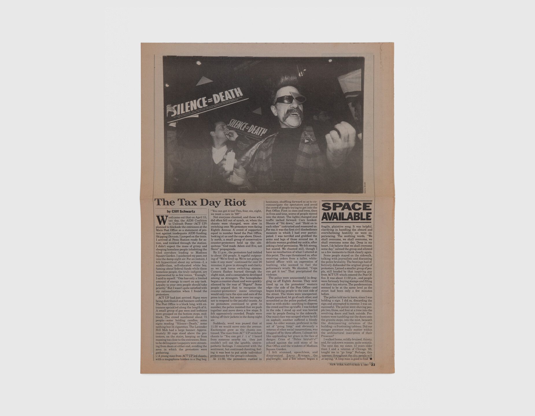 A photo of a newspaper article with a photo by Donna binder showing the first time Silence=Death was used in a demonstration, at the second Act Up demonstration in 1987.