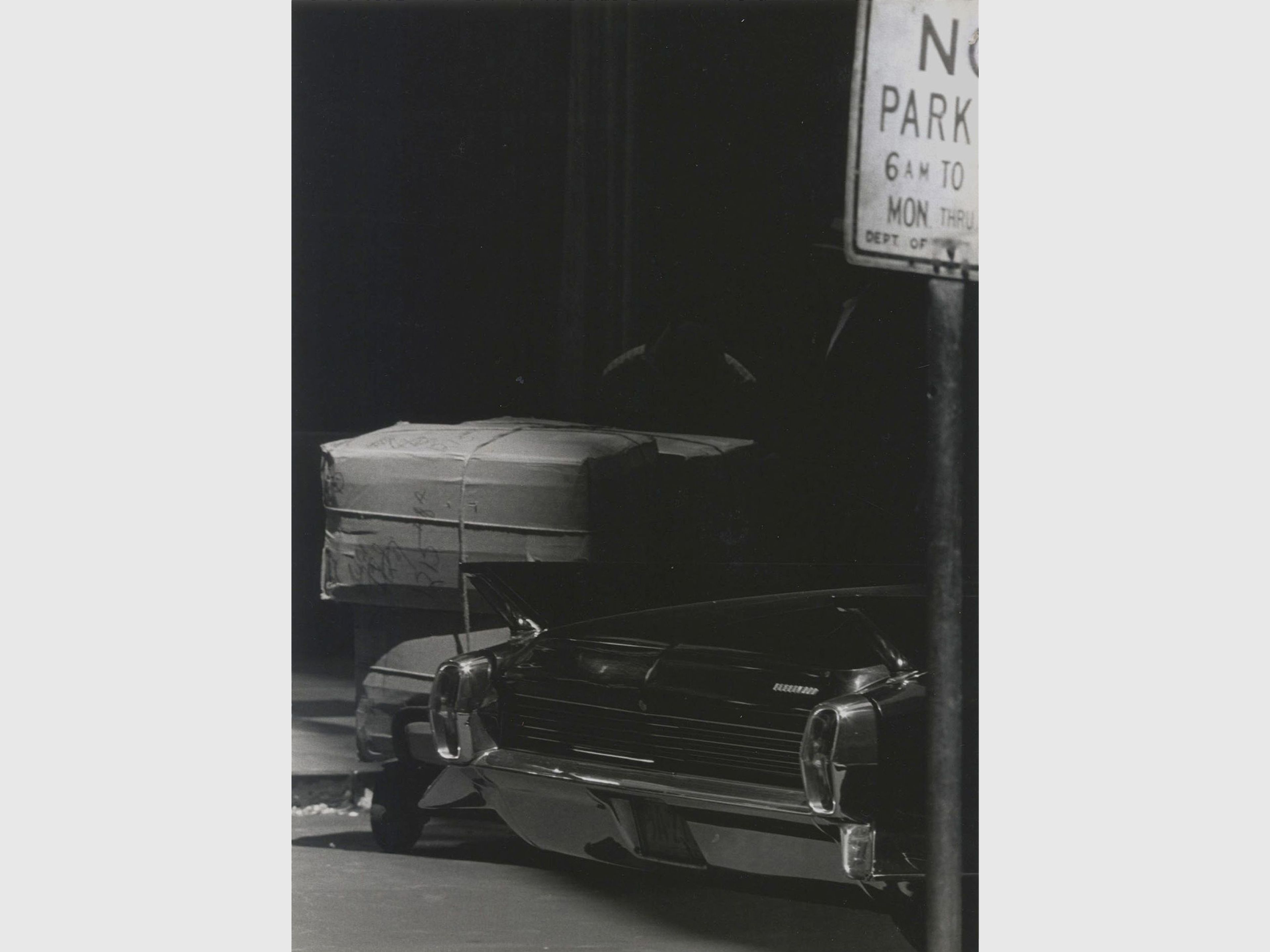 A photograph by Roy de Carava titled Two men boxes and car, dated 1966.