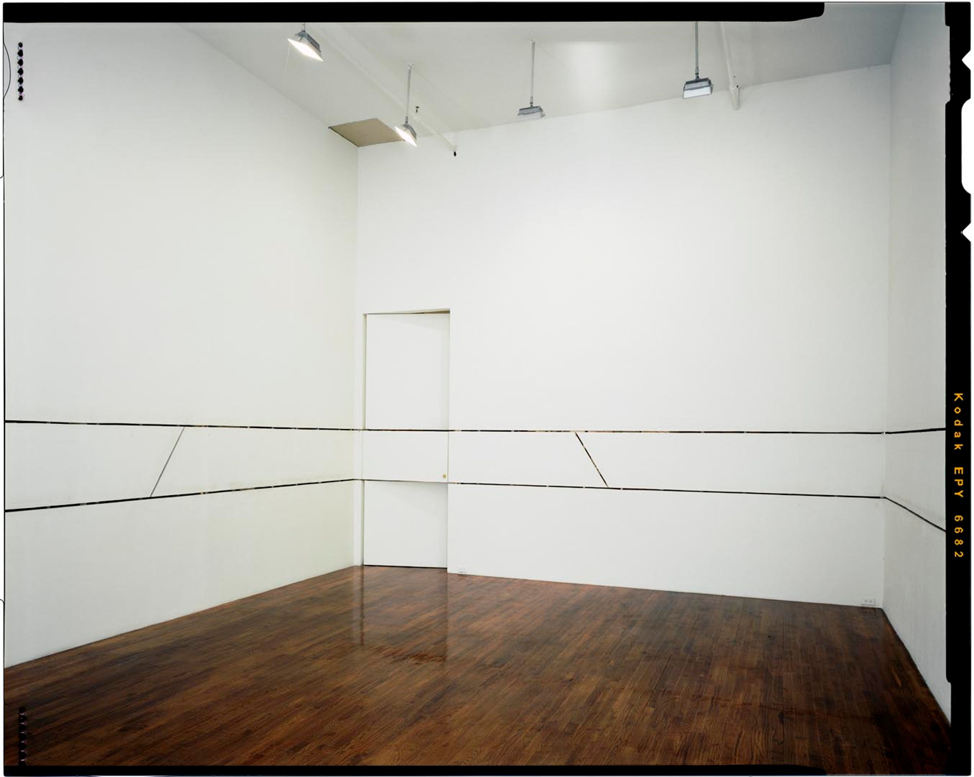 An installation view of the exhibition Gordon Matta-Clark: A W-Hole House and Selected Drawings, at David Zwirner New York, dated 2002.