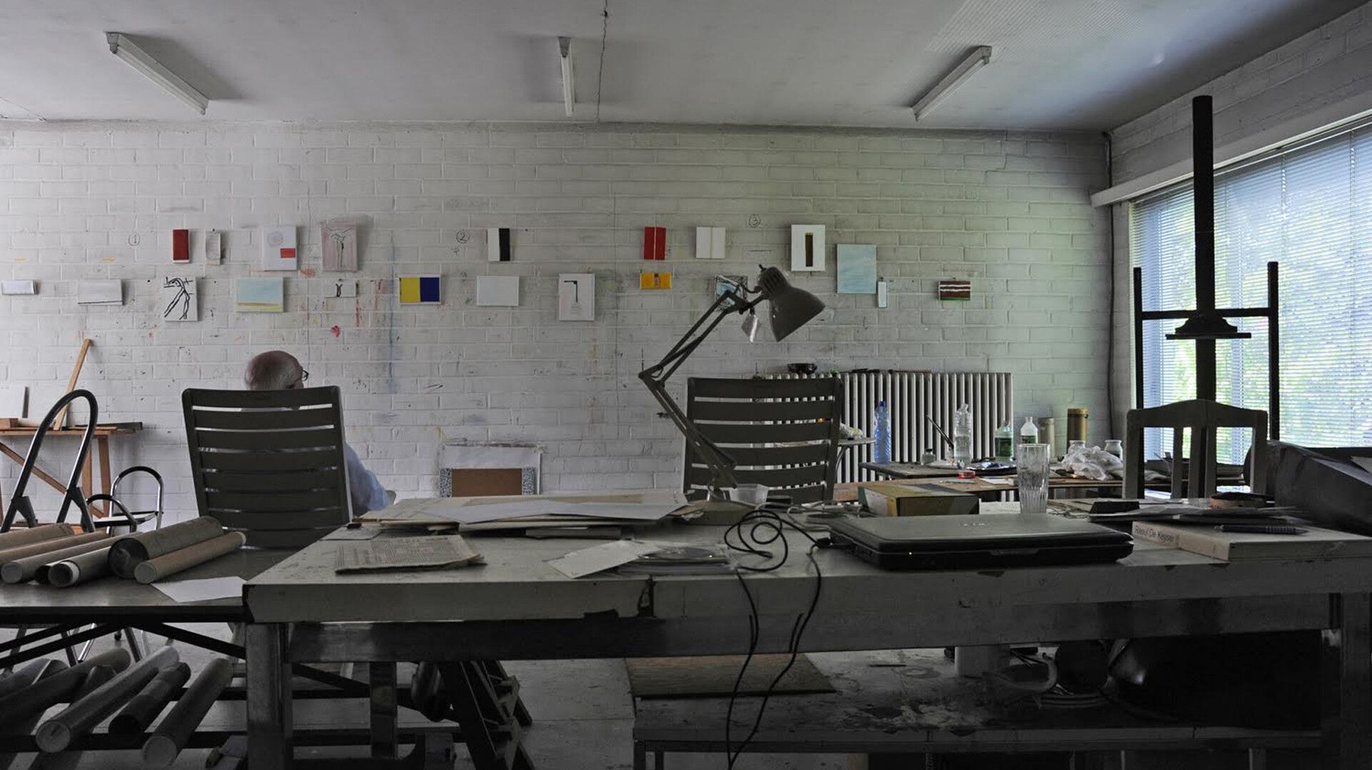 Raoul De Keyser in his studio with a view of works from The Last Wall, 2012. Photo by Jef Van Eynde