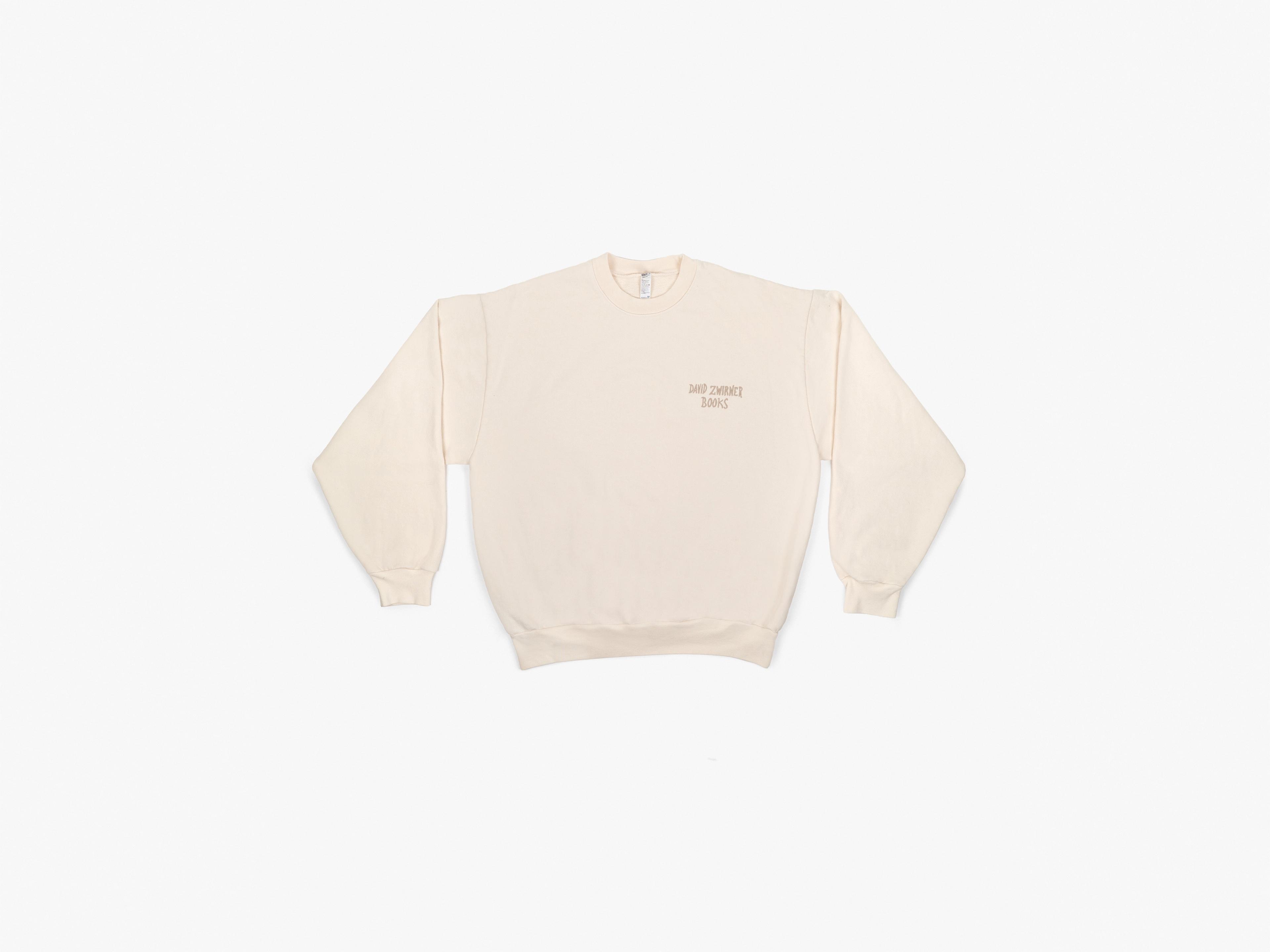 An oversized crewneck in heavyweight cotton fleece, in creme, featuring embroidered handwriting by Marcel Dzama.