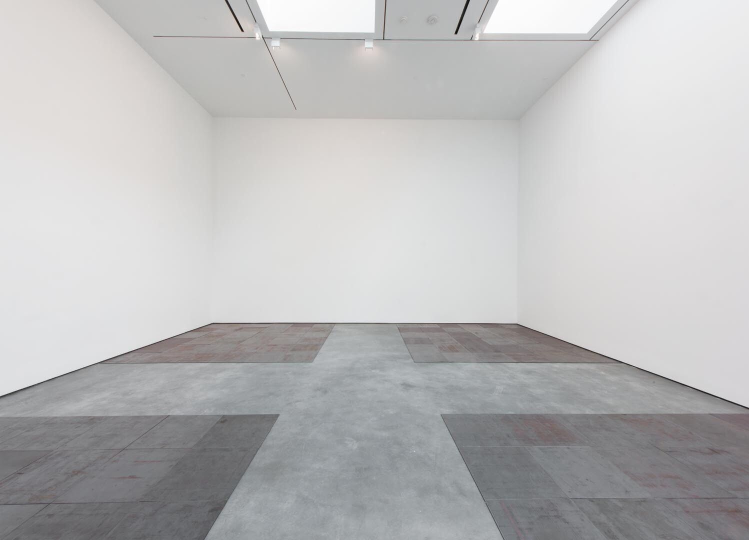 Installation view of the exhibition Andre, Flavin, Judd, McCracken, Sandback, at David Zwirner in New York, dated 2012. 
