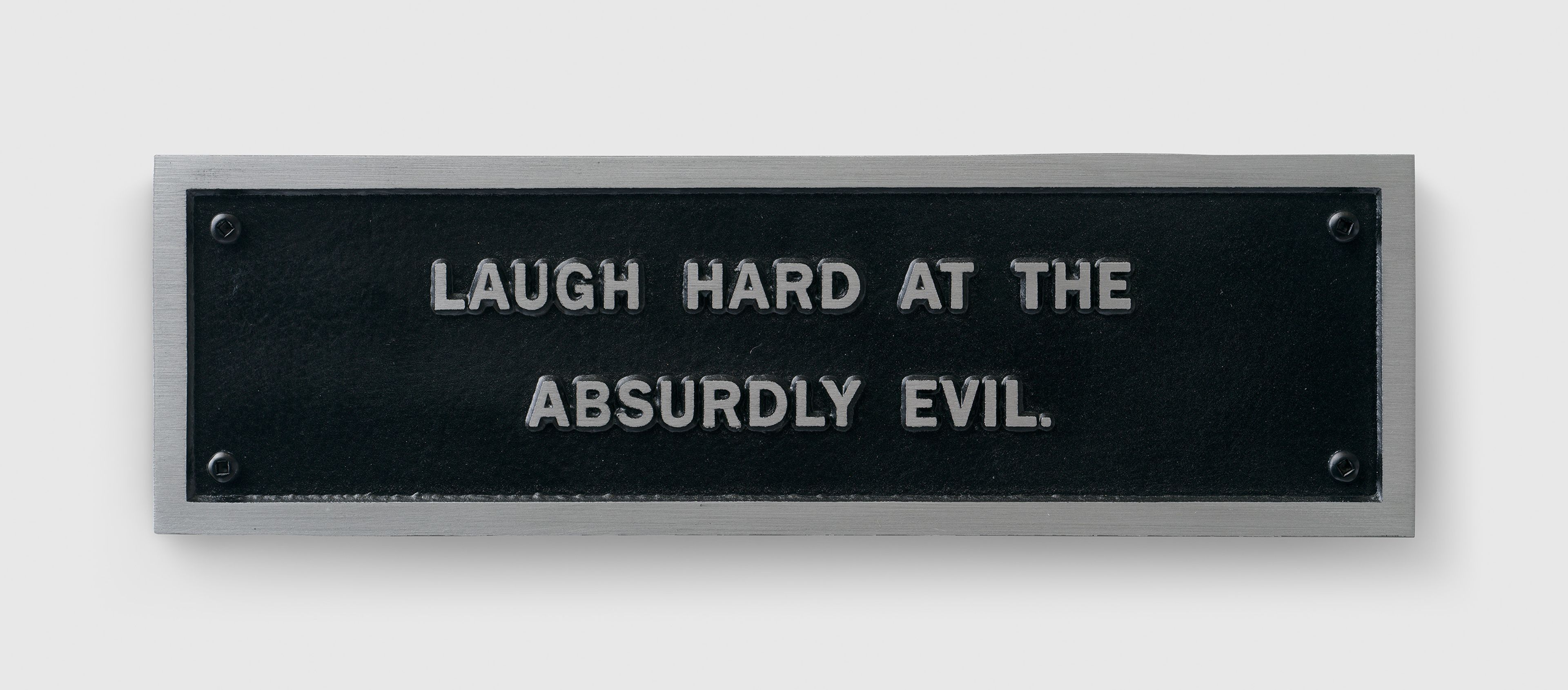 A sculpture by Jenny Holzer, titled Survival: Laugh hard at the absurdly evil, dated 1984.