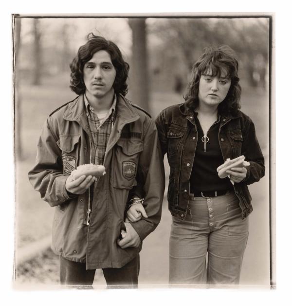 Diane Arbus — A young man and his girlfriend with hot dogs in the park, N.Y.C., 1971