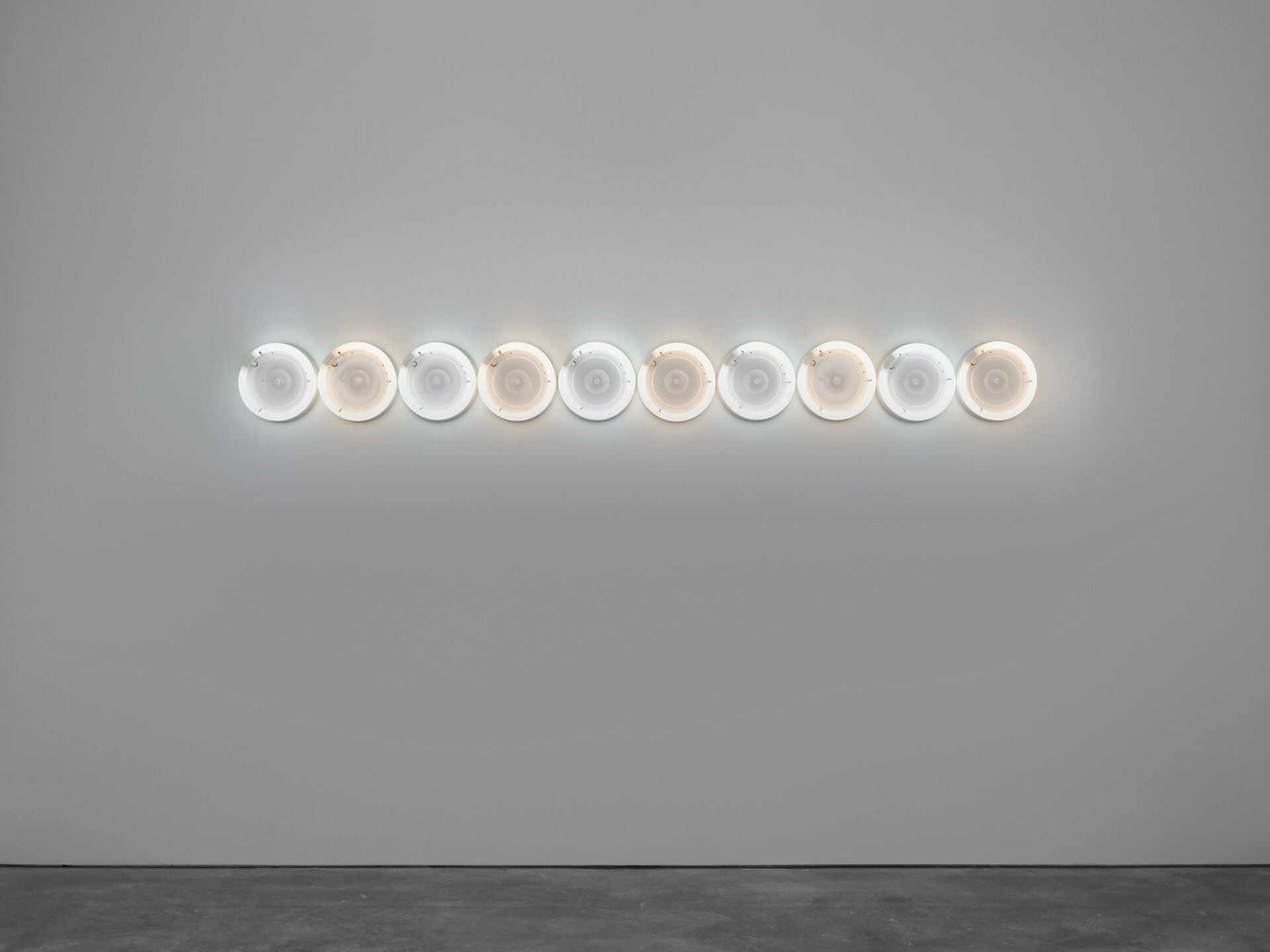 An untitled cool white and warm fluorescent light sculpture by Dan Flavin, dated 1973.