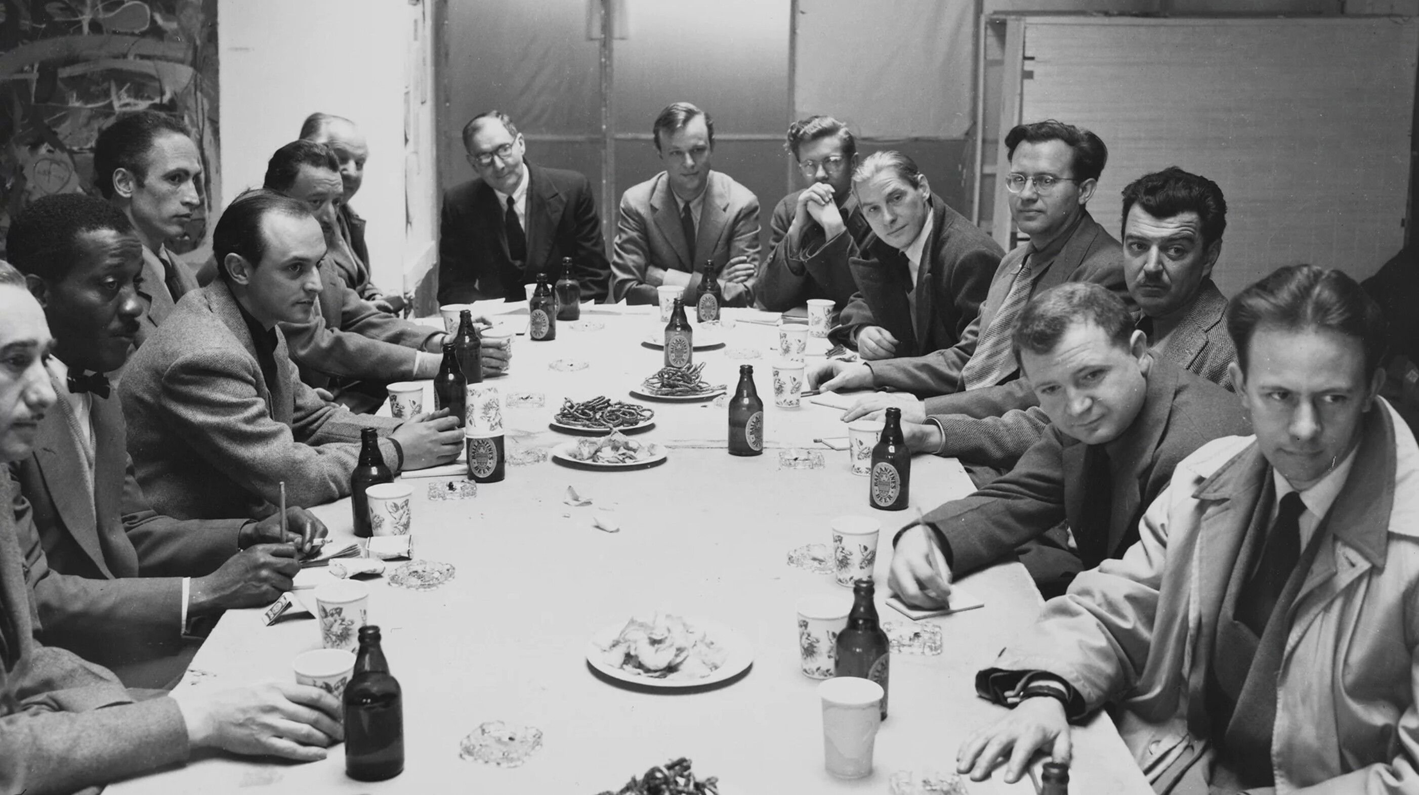 Ad Reinhardt sitting at a dining table during a session at Studio 35