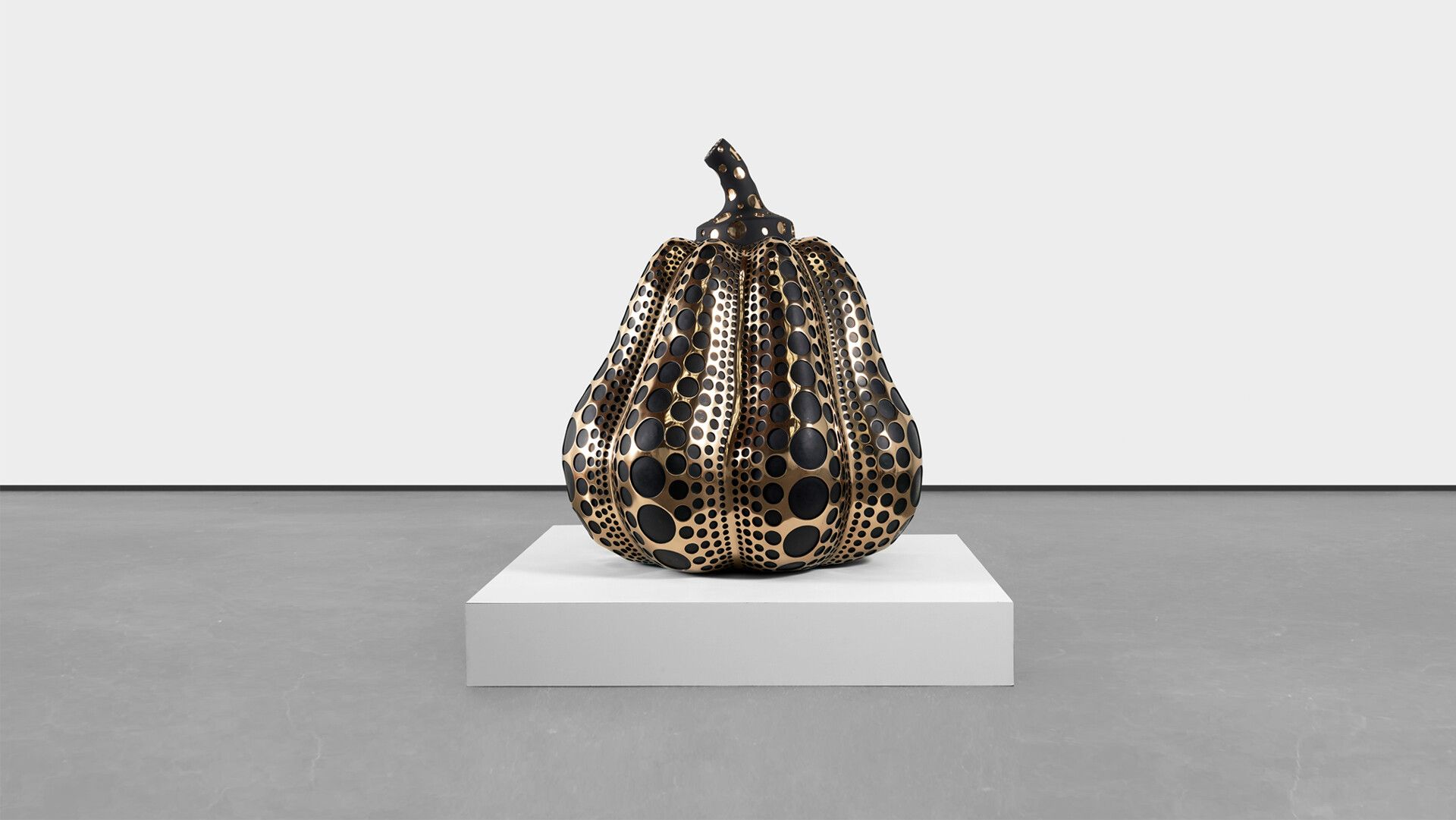 A mirror polished bronze, dye, and acrylic lacquer sculpture by Yayoi Kusama, titled Pumpkin (M), dated 2016.