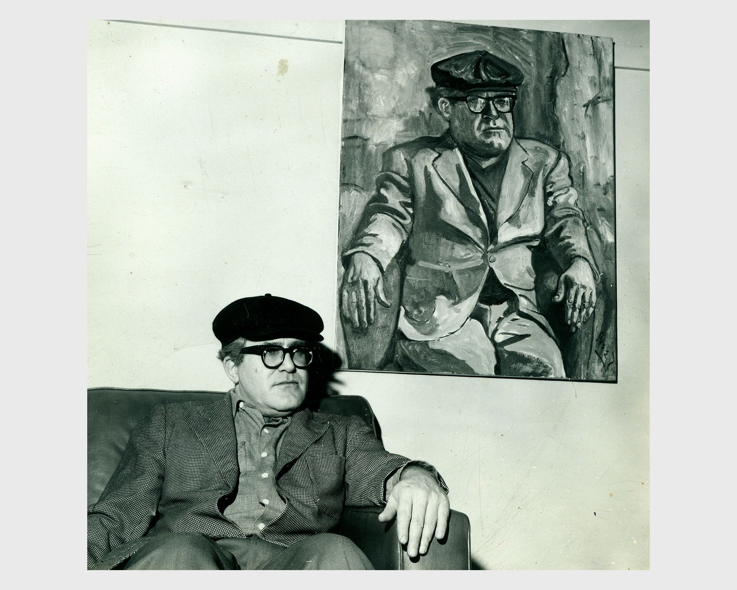 A photo of Hub Crehan sitting with his portrait circa 1961