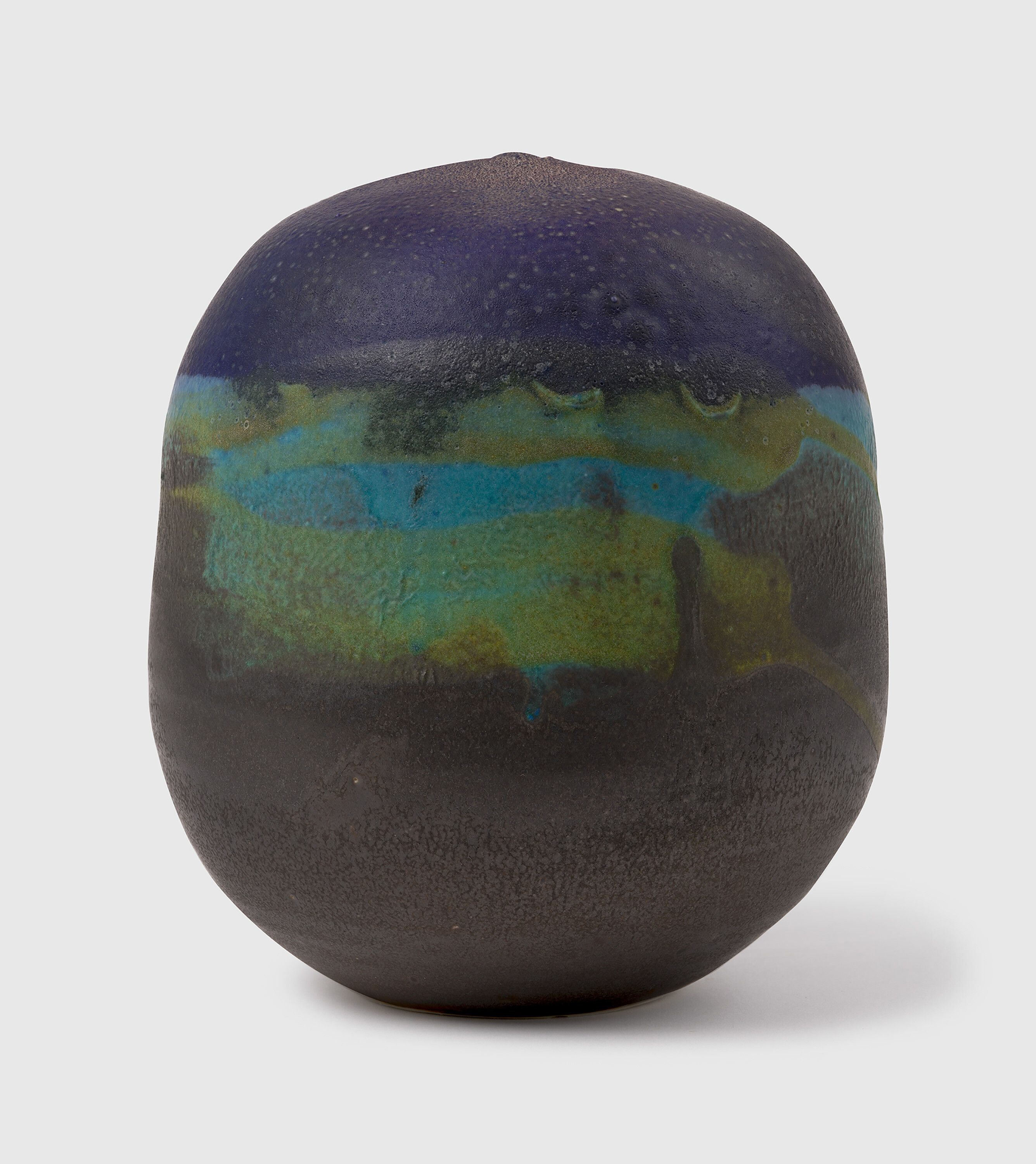 A sculpture by Toshiko Takaezu, called Untitled Deep Purple “Ocean Edge” Closed Form, circa 1995.