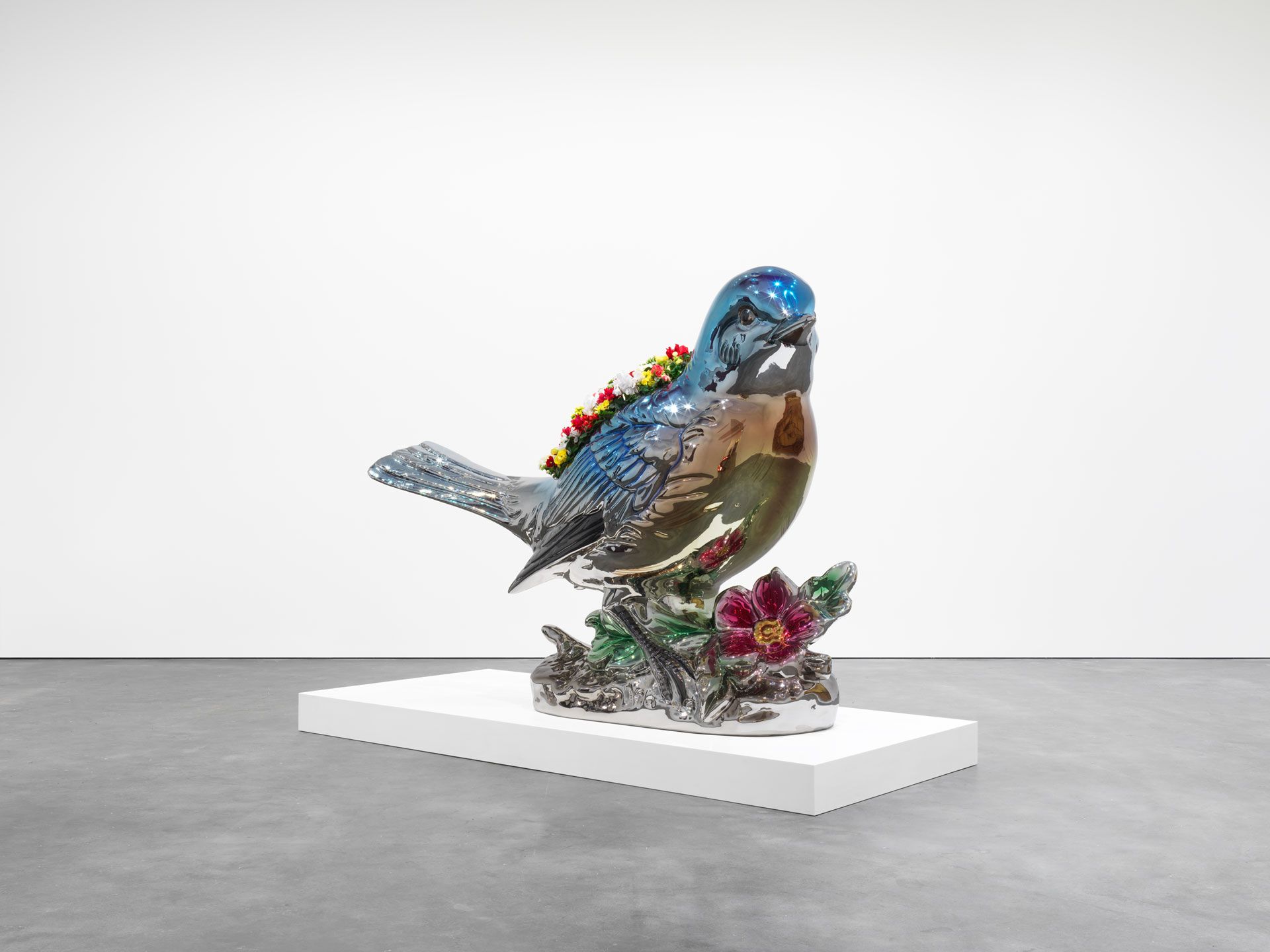 A mirror polished stainless steel sculpture with live flowering plants by Jeff Koons titled Bluebird Planter, dated 2010-2016.