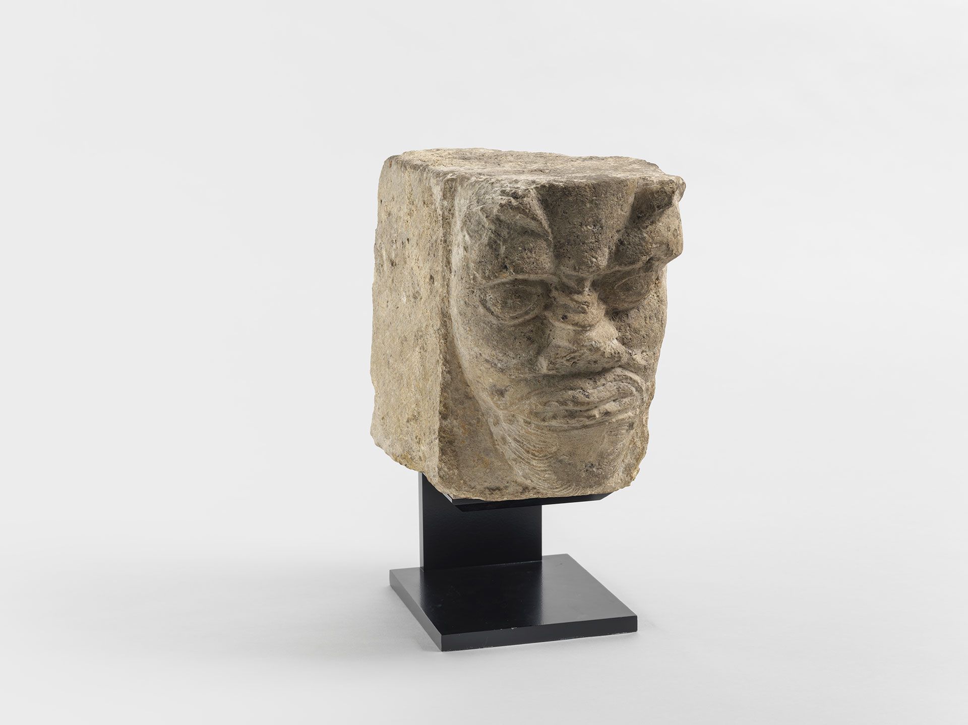 A sculpture by an anonymous artist, titled A Grotesque Head from a Corbel, dated in the 12th century.