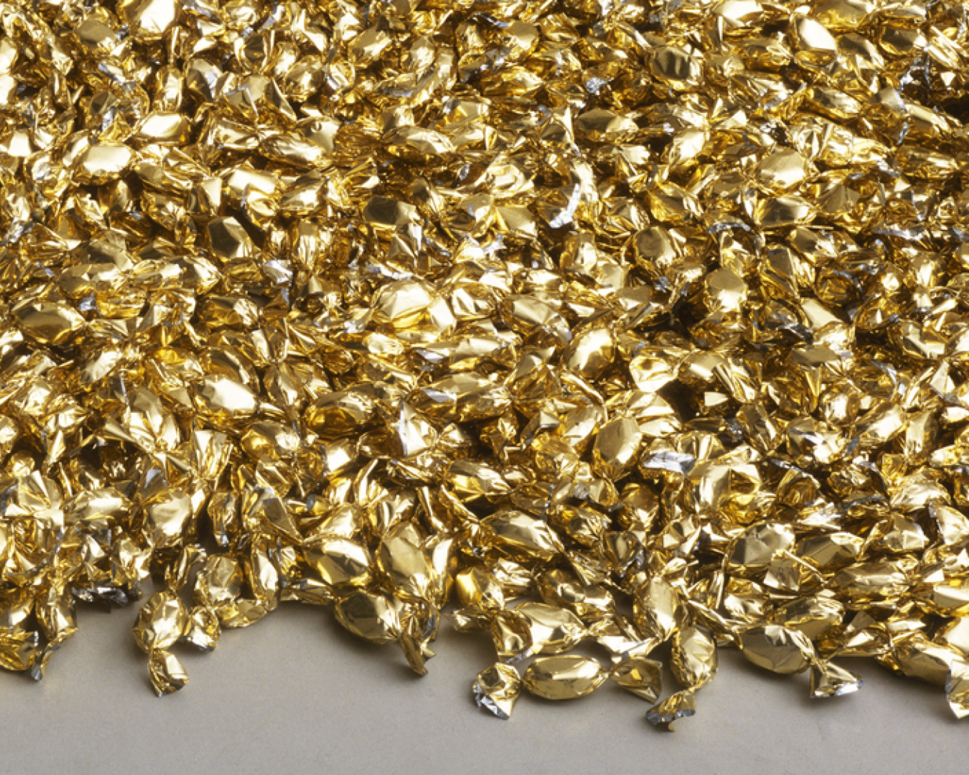Close-up of a pile of gold-foil-wrapped candies from Felix Gonzalez-Torres’s “Untitled” (Placebo – Landscape – for Roni).