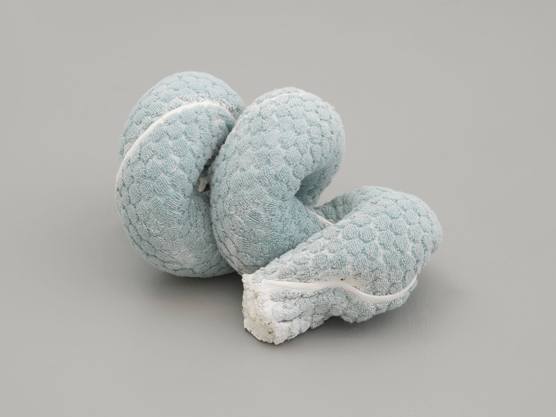 A sculpture by Oren Pinhassi, titled Towel Snake (Turquoise), dated 2018.