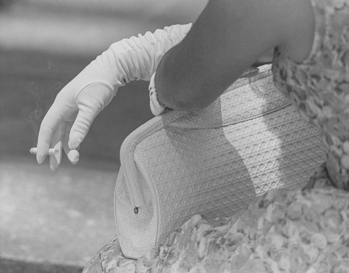 A silver gelatin print by Roy DeCarava, titled White glove and cigarette, dated 1962.