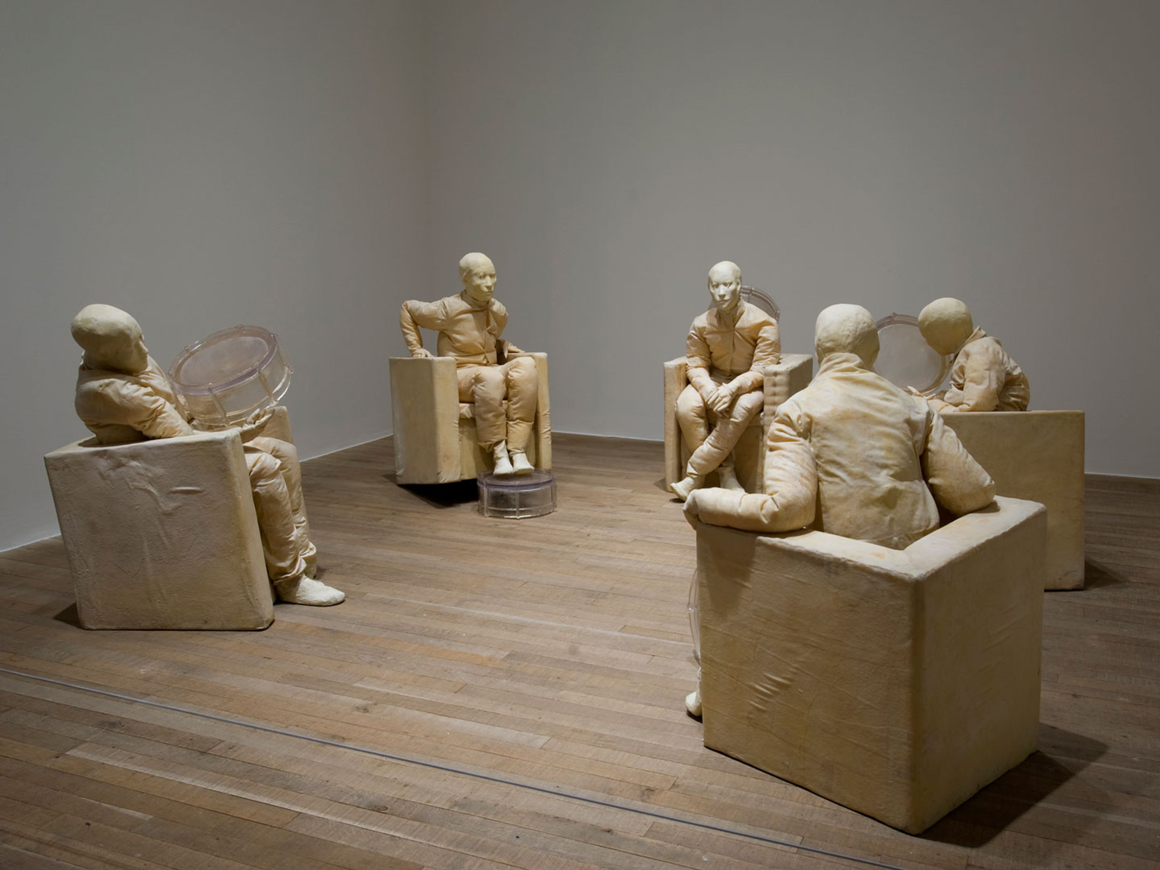 A mixed media sculpture by Juan Muñoz, titled Seated Figures with Five Drums, at Tate Modern, in London, England, in 2008.