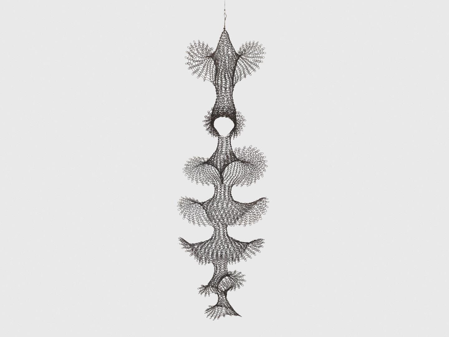 A hanging steel wire sculpture by Ruth Asawa, titled Untitled (S.636, Hanging Open Windows Form with Seven Tiers), circa 1950 to 1953.