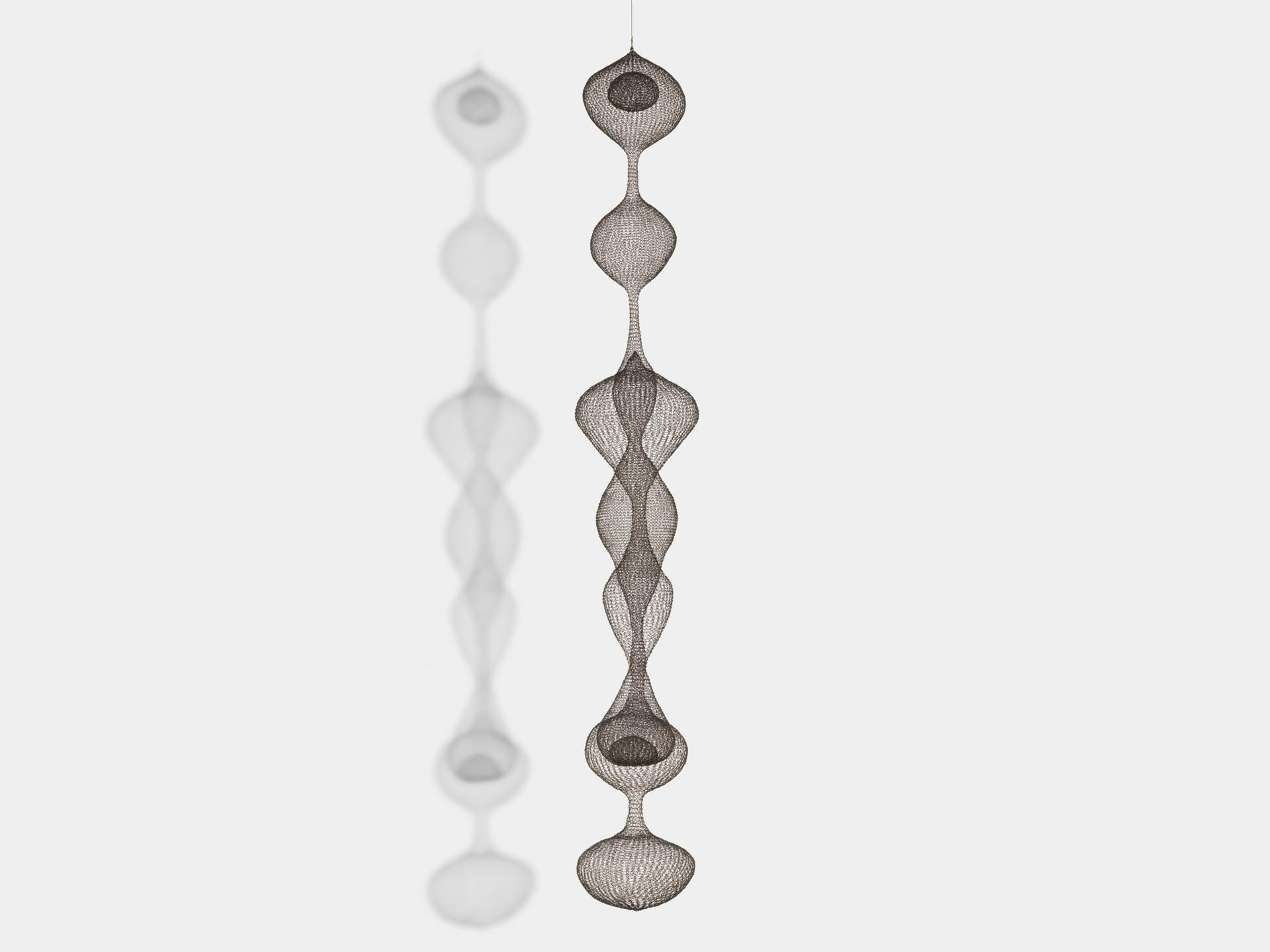A sculpture by Ruth Asawa, titled Untitled (S.272, Hanging Seven-Lobed, Continuous Interwoven Form, with Spheres within Two Lobes), dated circa 1954.