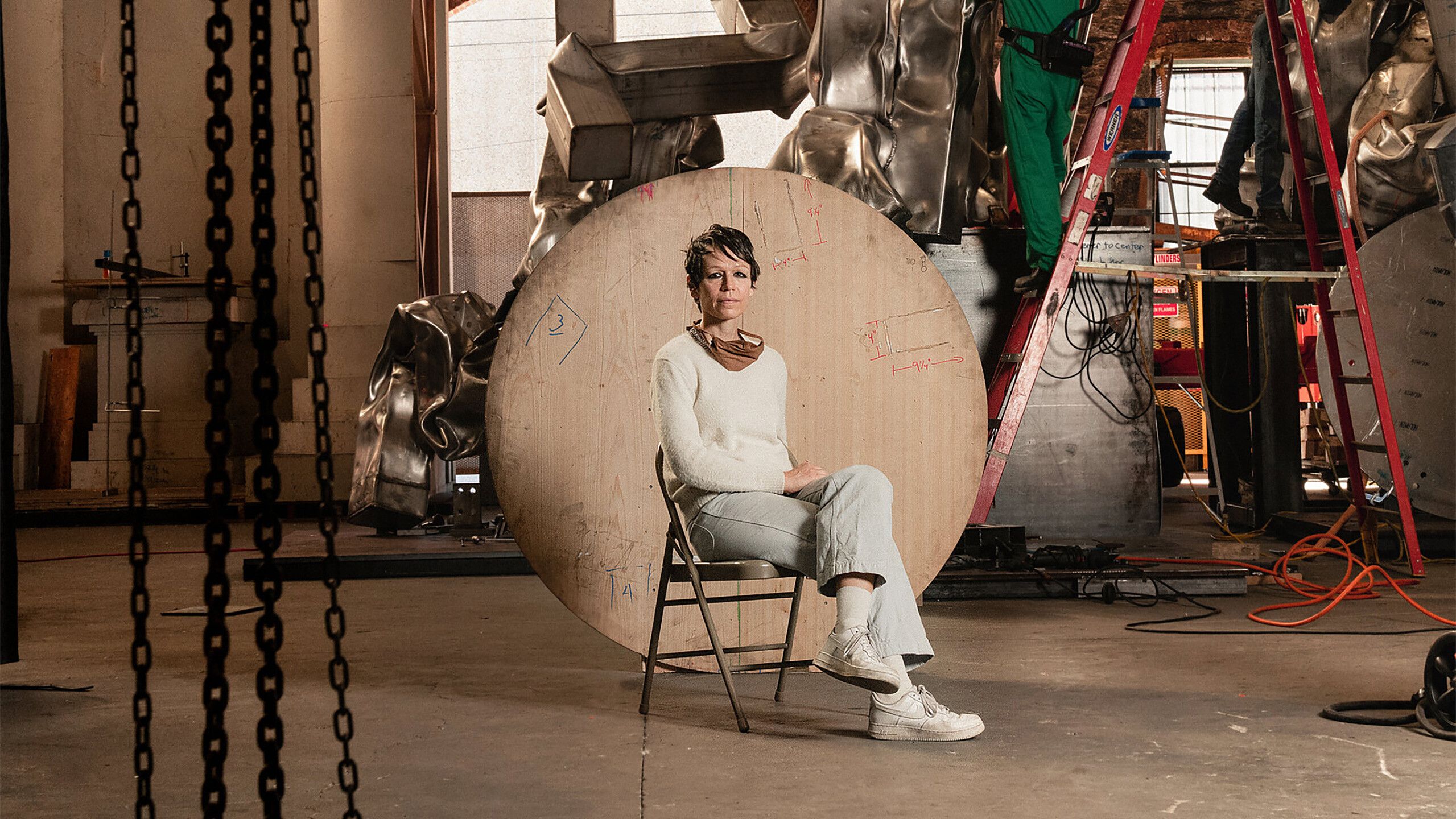 A photograph of Carol Bove in her studio, dated 2020