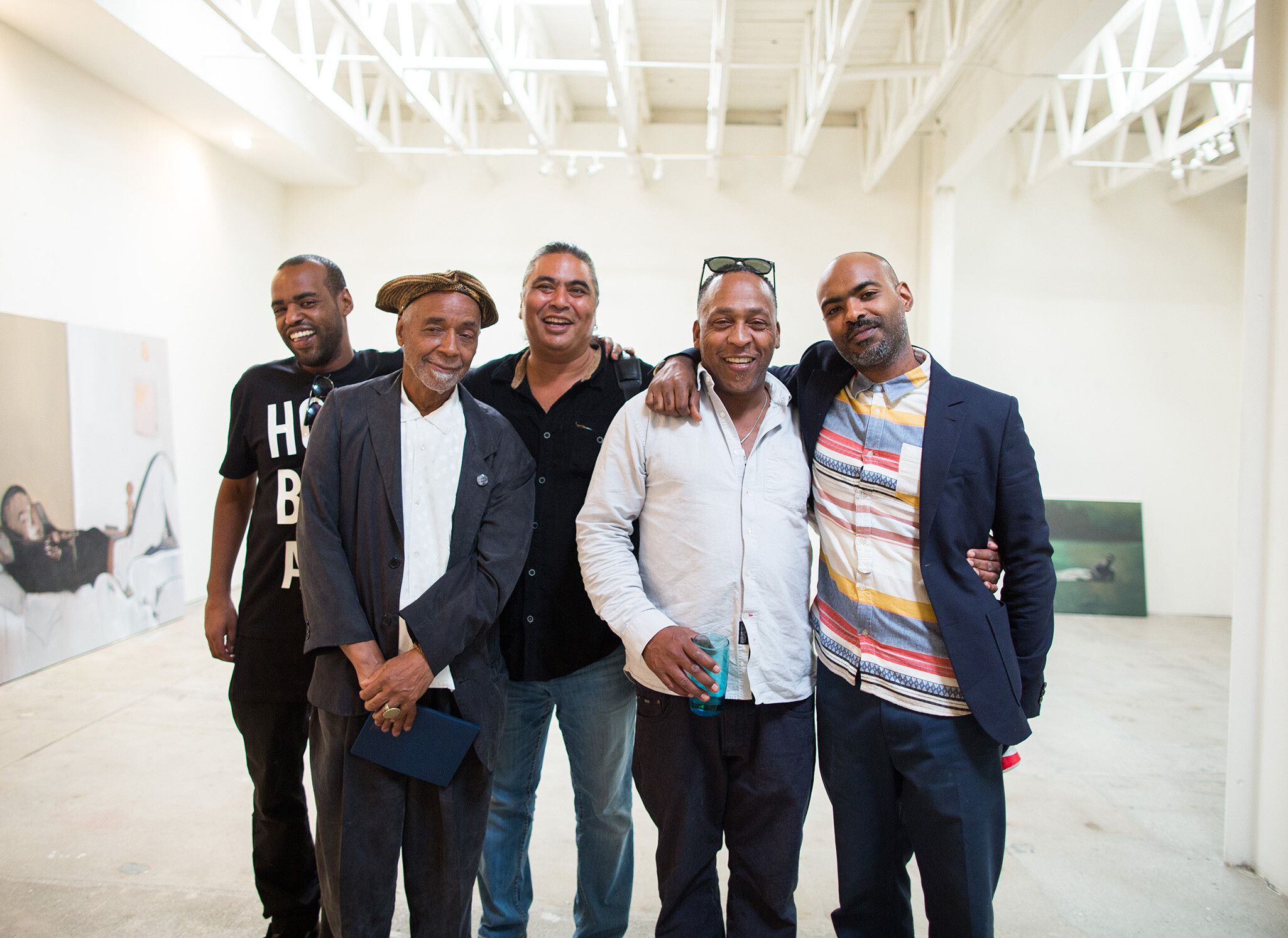 A photo of Noah Davis, David Hammons, Ian White, Henry Taylor, and Kahlil Joseph, at the Underground Museum, Los Angeles, in 2015.