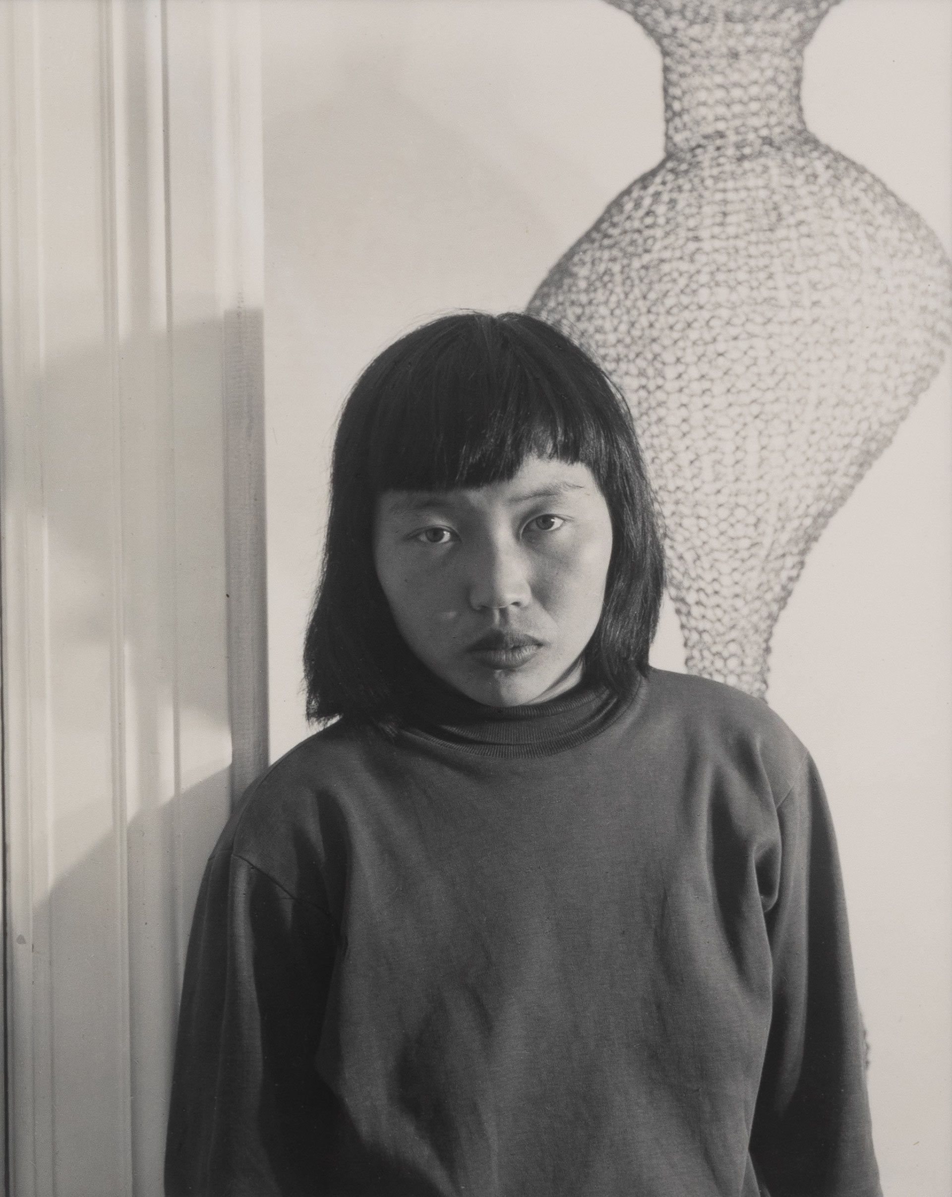 A photo titled Ruth Asawa and Her Wire Sculpture, dated 1951. Photo by Imogen Cunningham.