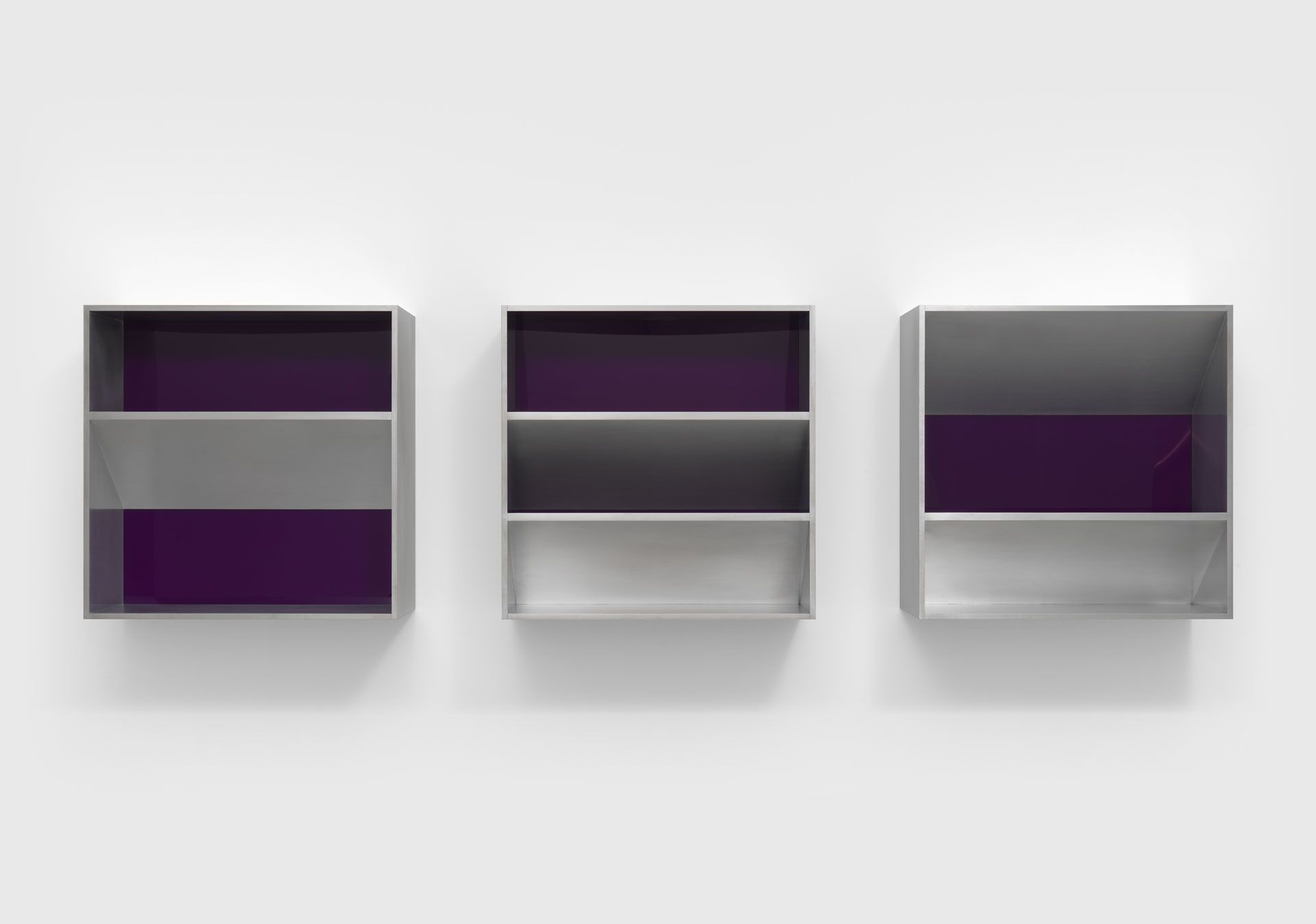 An untitled aluminum and purple acrylic sheets sculpture in three units by Donald Judd, dated 1982.