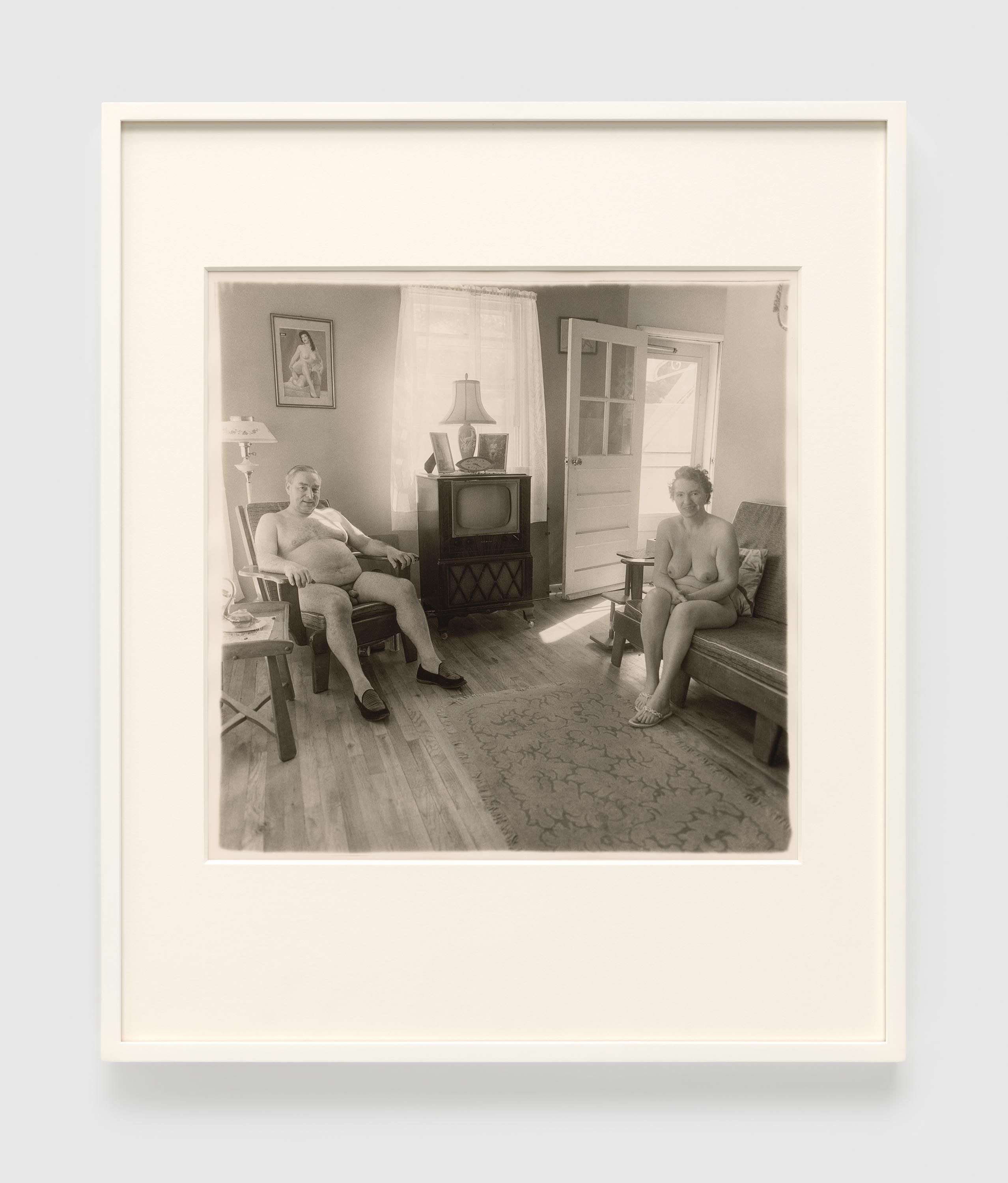 A gelatin silver print by Diane Arbus, titled Retired man and his wife at home in a nudist camp one morning, N.J. 1963, dated 1963.