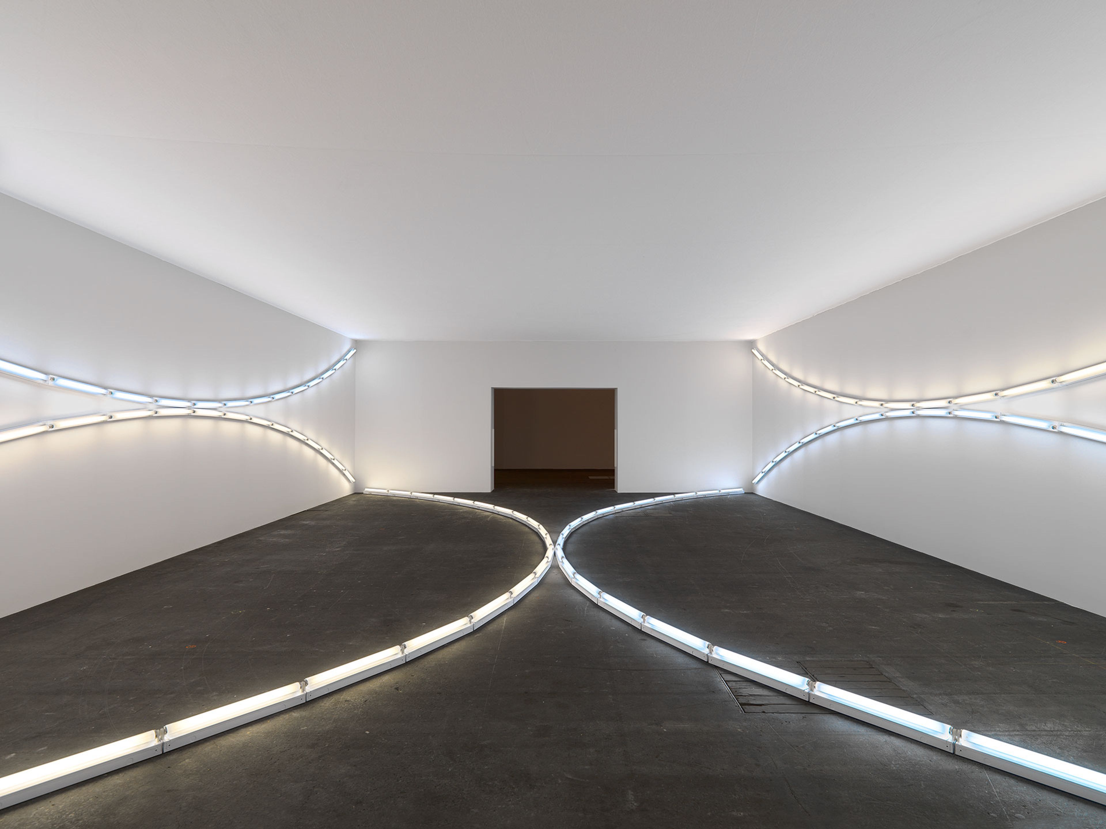 A sculpture in daylight and cool white fluorescent light by Dan Flavin, titled three sets of tangented arcs in daylight and cool white (to Jenny and Ira Licht), dated 1969.